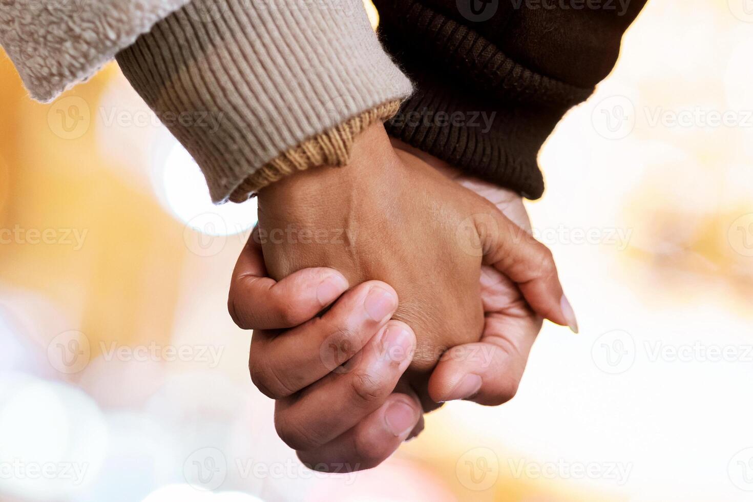 Love, Affection And Bonding Concept. Close up outdoor protrait of unrecognizable black african american couple holding hands, walking together in the city in the evening. Romantic Relationship photo