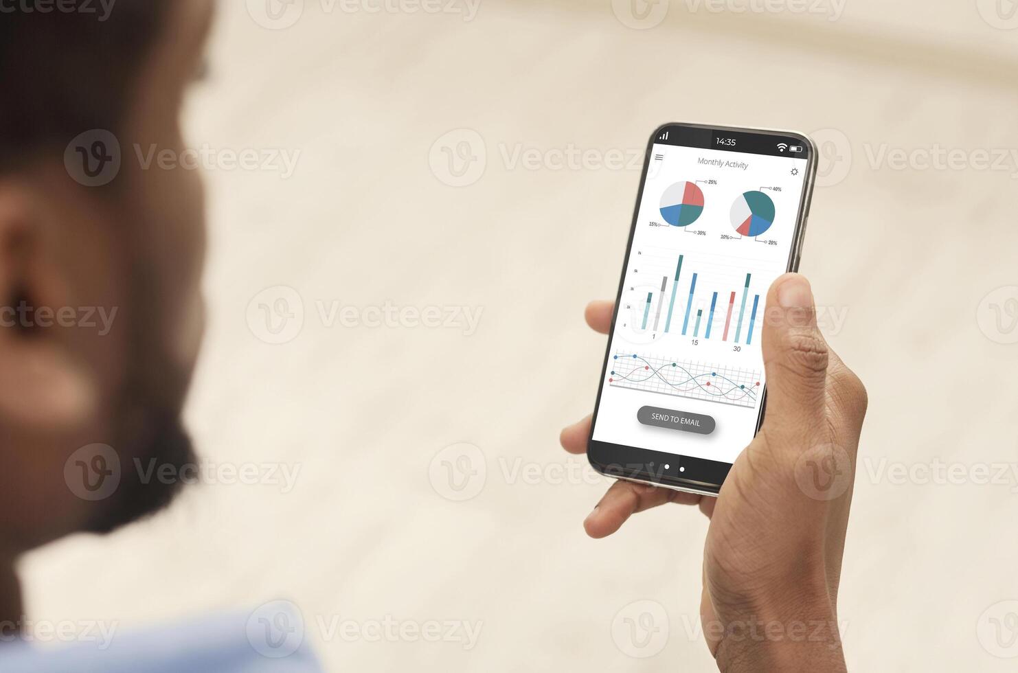 Cropped of black man using analytics mobile app on smartphone, checking his incomes on trading stocks, panorama. Male hands holding phone with newest analytics mobile application photo