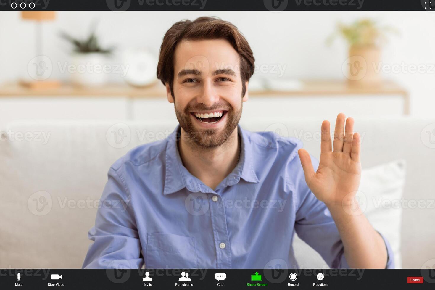 Hello. Happy Man Waving Hand Smiling To Camera Sitting On Couch At Home. Cheerful Guy Gesturing Hi Greeting Making Call Indoors. Modern Remote Communication Concept photo