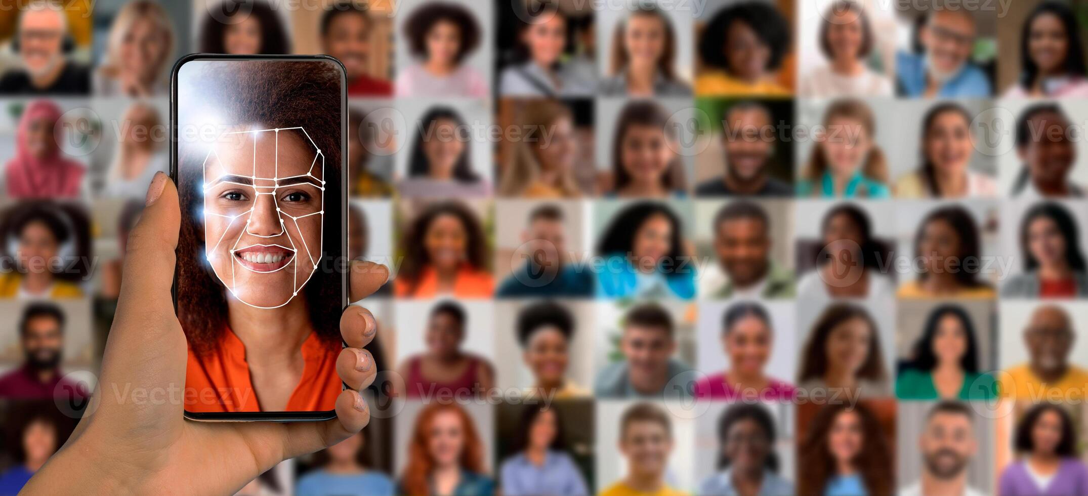 A hand holds a smartphone displaying facial recognition software. The screen shows a woman's face outlined for identification. photo