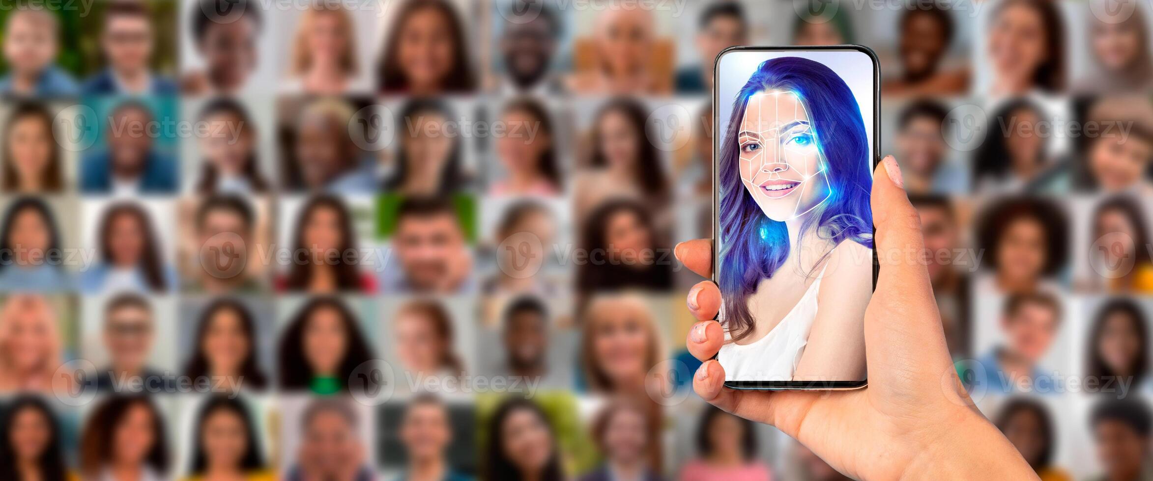 A hand holds a smartphone displaying a face scan in front of a collage of diverse portraits. This scene illustrates advanced identification technology in use today. photo