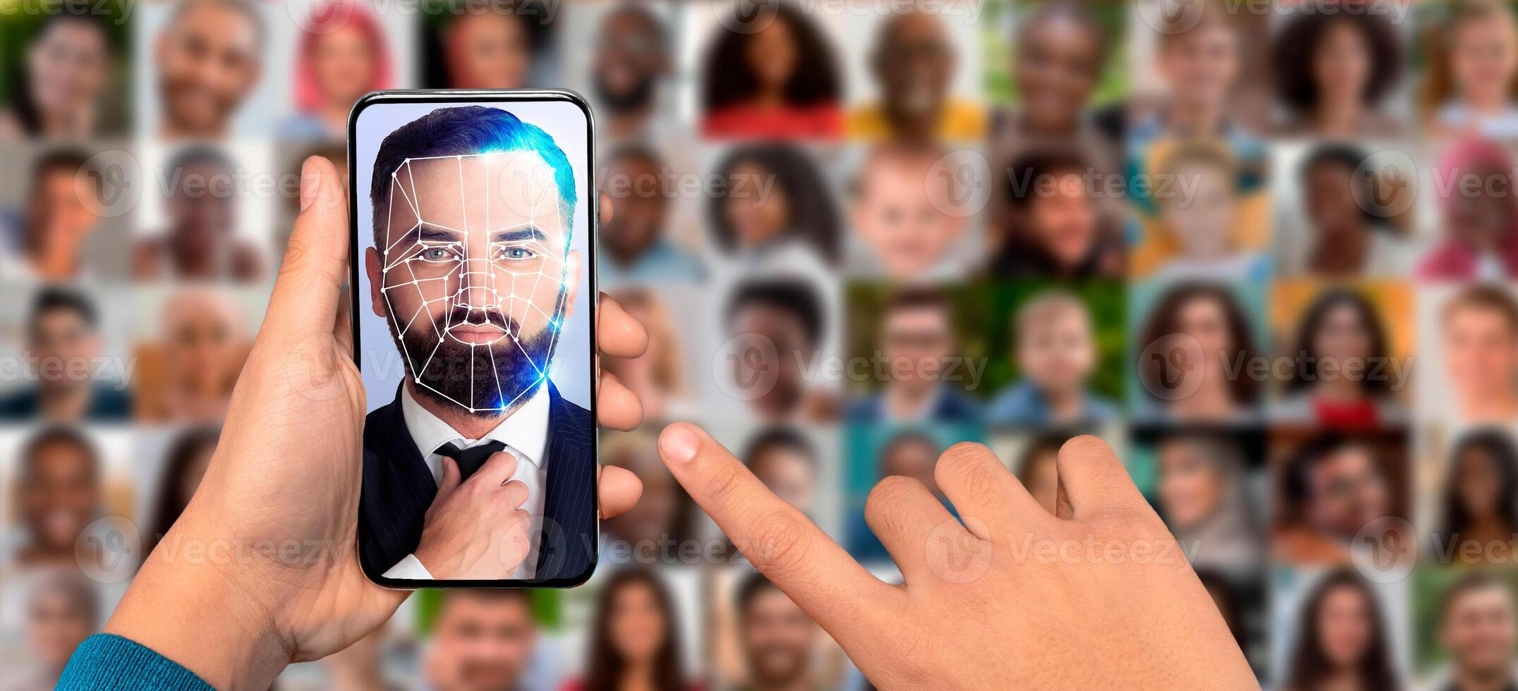 A hand holds a smartphone displaying a man face with digital facial recognition lines overlaid. photo