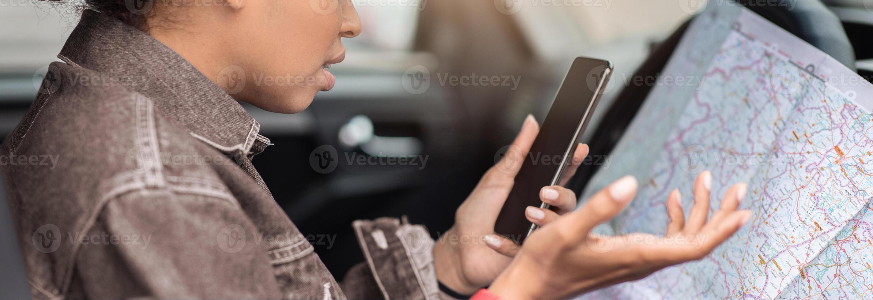 No connection and error in location, modern gadgets and online map. Sad millennial african american female got lost on road, sits in car with chart, looks at smartphone and spreads her arms, profile photo
