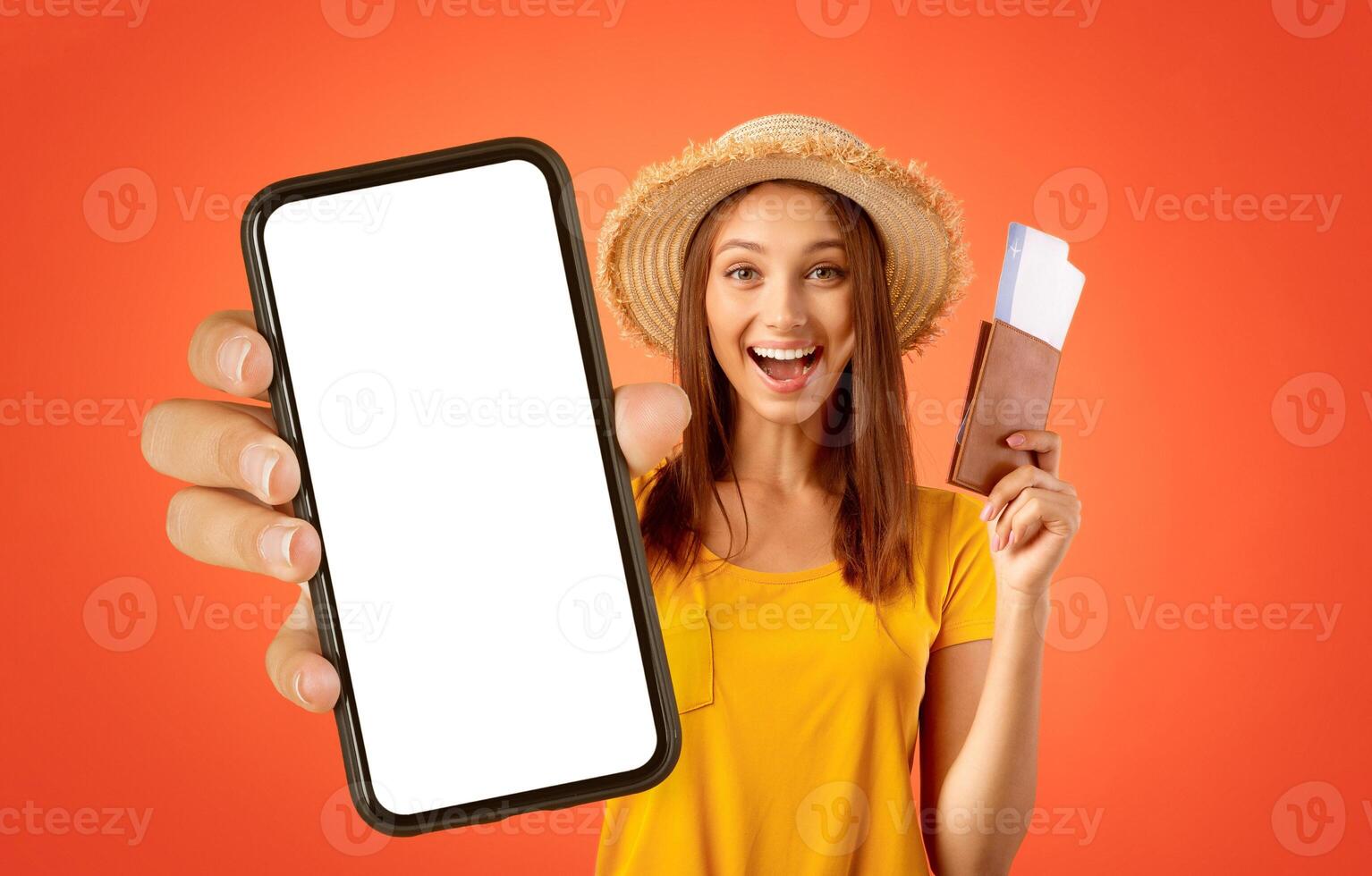 Emotional female traveller with passport and tickets in her hand showing thumb up, yellow studio background photo