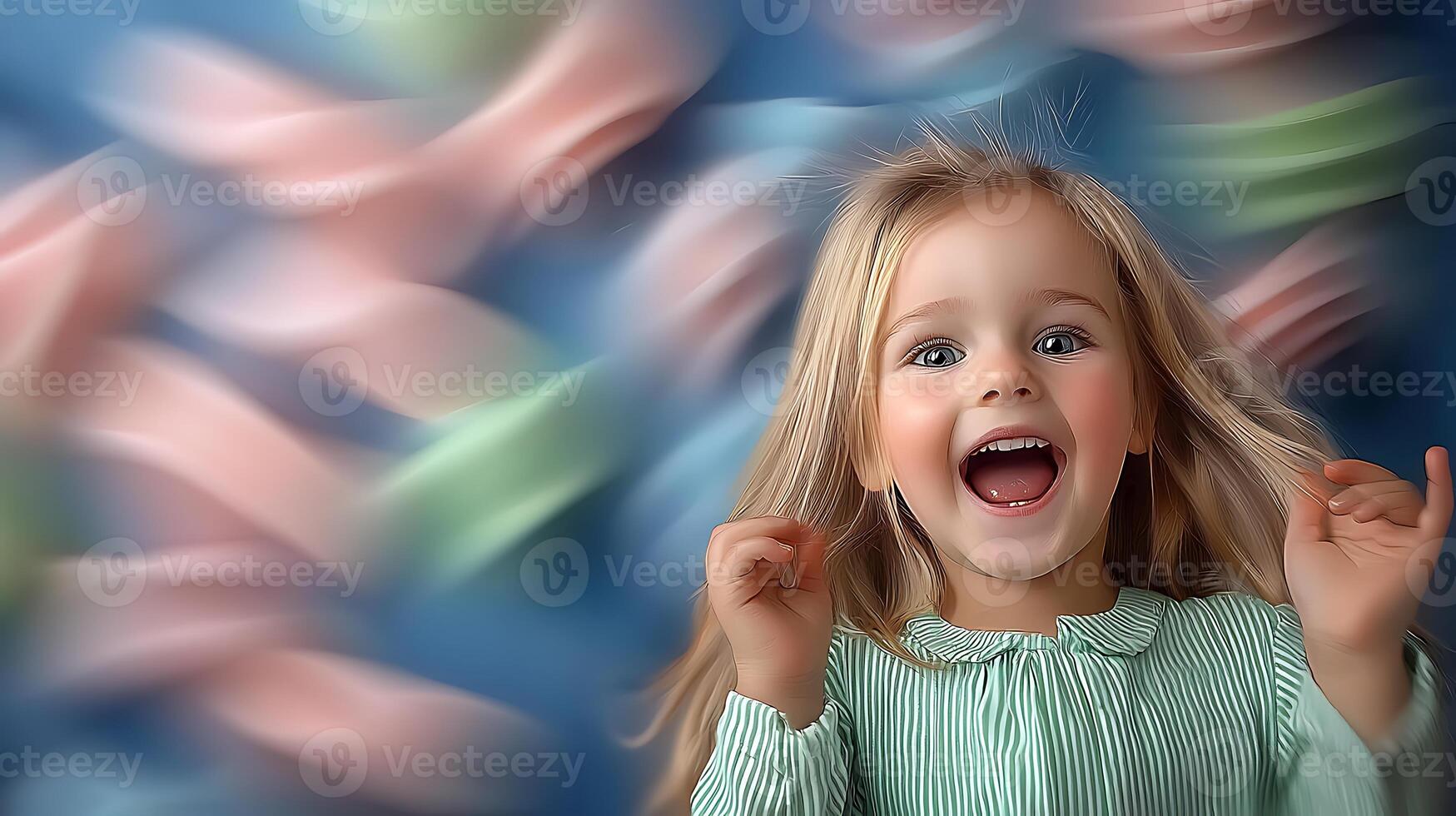 A joyful child with long hair, smiling widely against a colorful, blurred background of soft fabrics photo