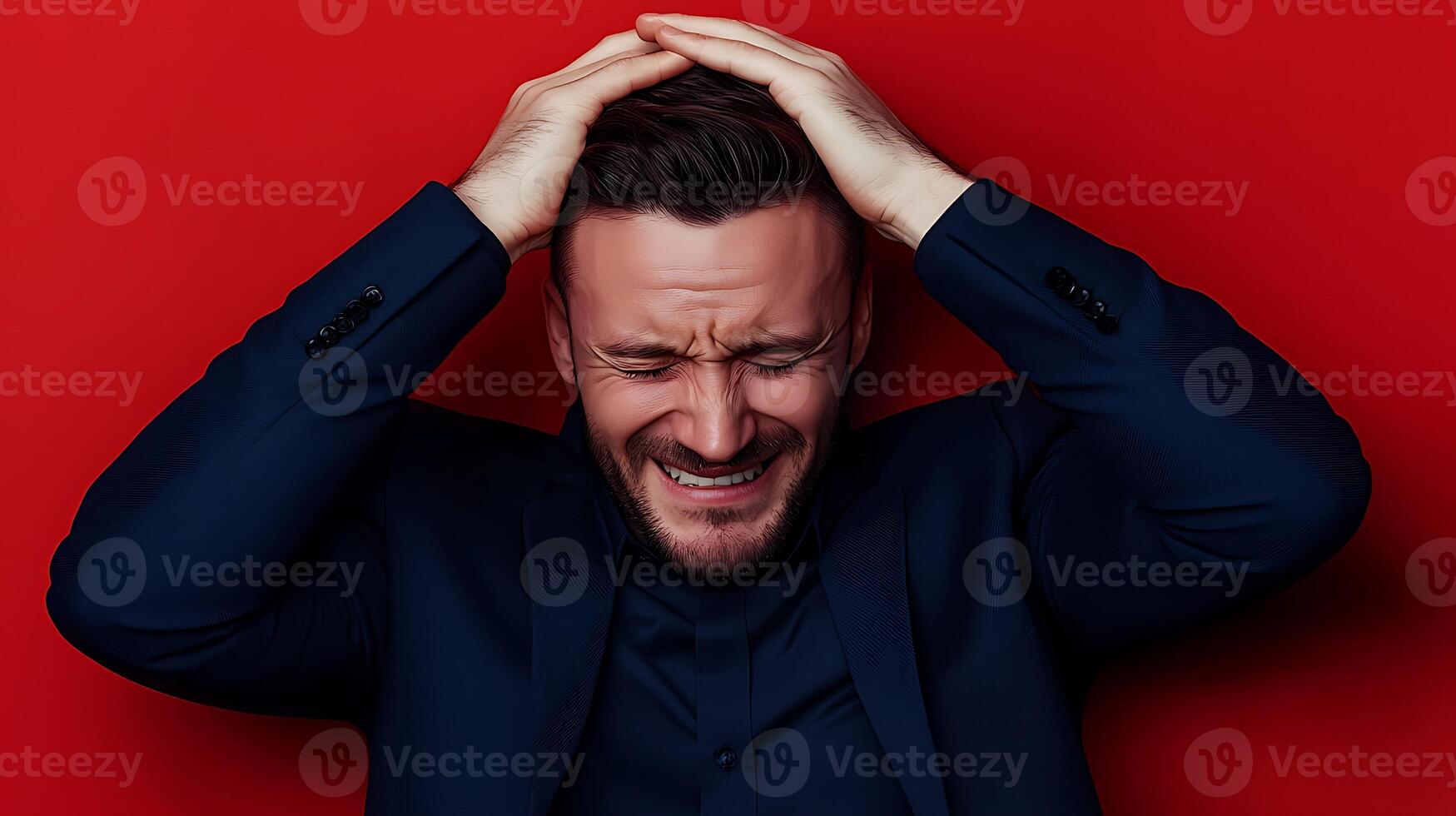 A man in a suit expressing frustration while holding his head against a vibrant red backdrop photo