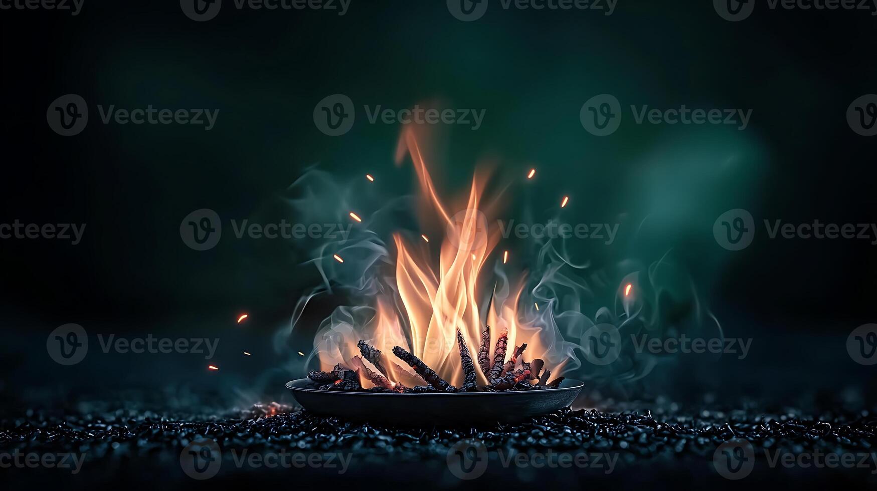 A mesmerizing close-up of a glowing fire in a dark setting, creating a warm ambiance photo