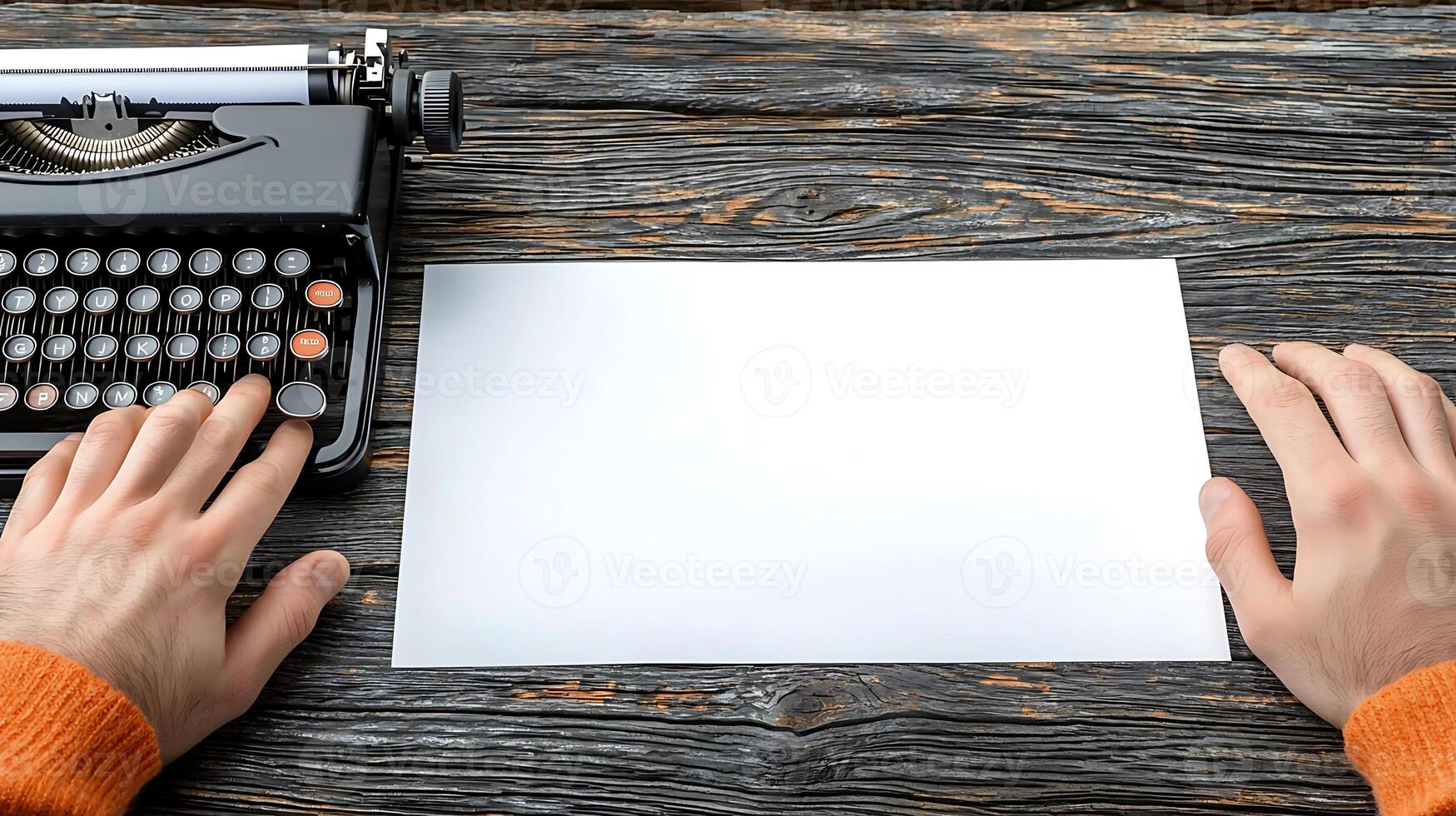 A person preparing to type on a vintage typewriter with a blank sheet on a rustic wooden table photo