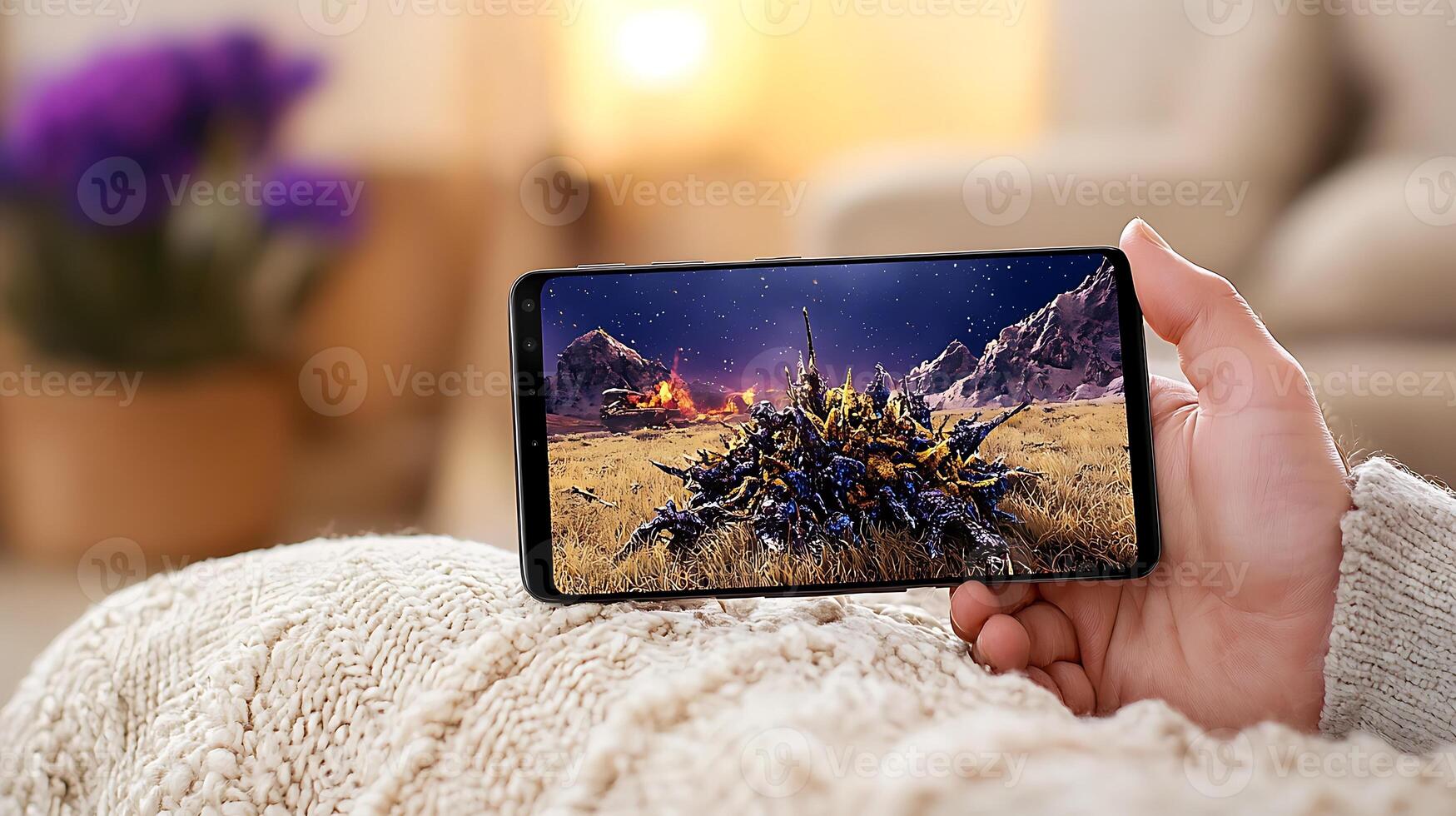 A person relaxing on a cozy couch, viewing a stunning landscape on a smartphone in a warm room photo