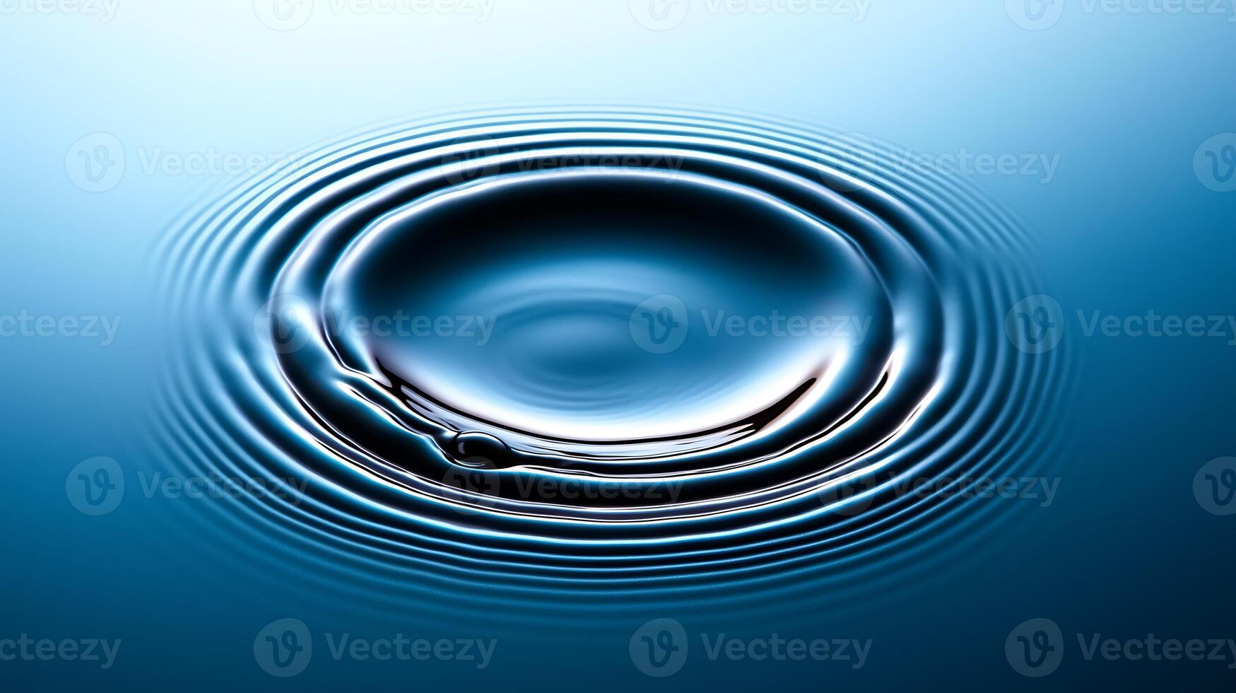 A serene close-up of water ripples forming a circular pattern, reflecting soft blue hues photo