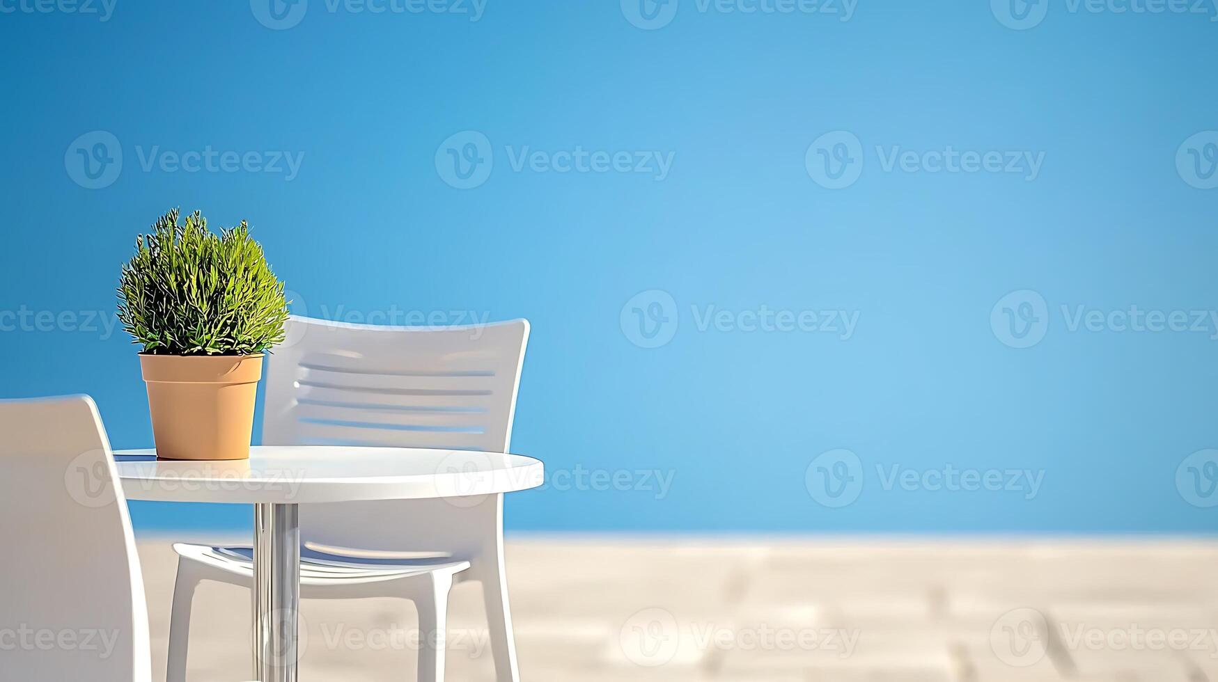 A serene outdoor setting featuring a potted plant on a white table with empty chairs against a blue sky photo
