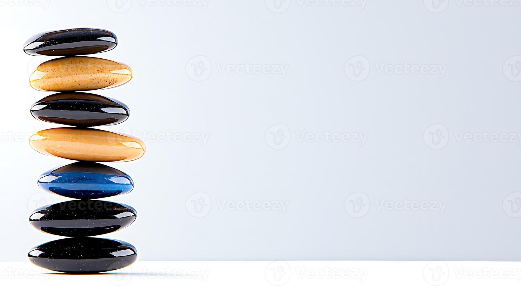 A serene stack of smooth, colorful stones balancing on a minimalist background, symbolizing harmony photo