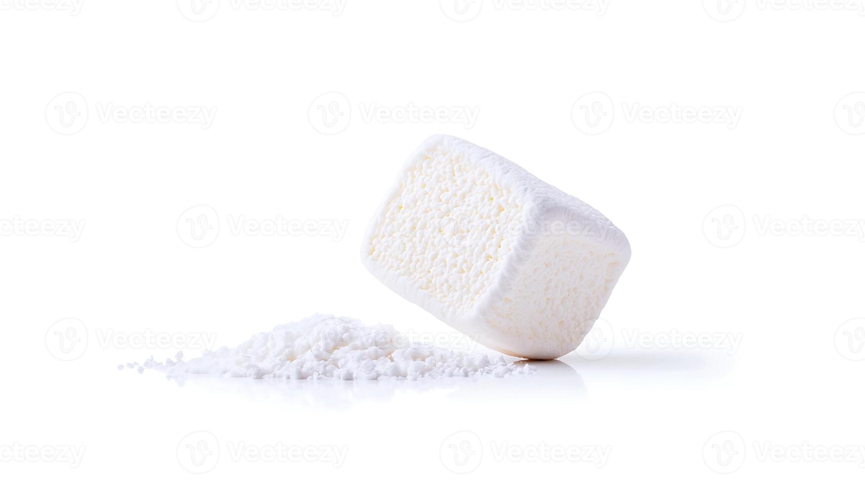 A single white sugar cube leaning on a pile of granulated sugar against a clean background photo