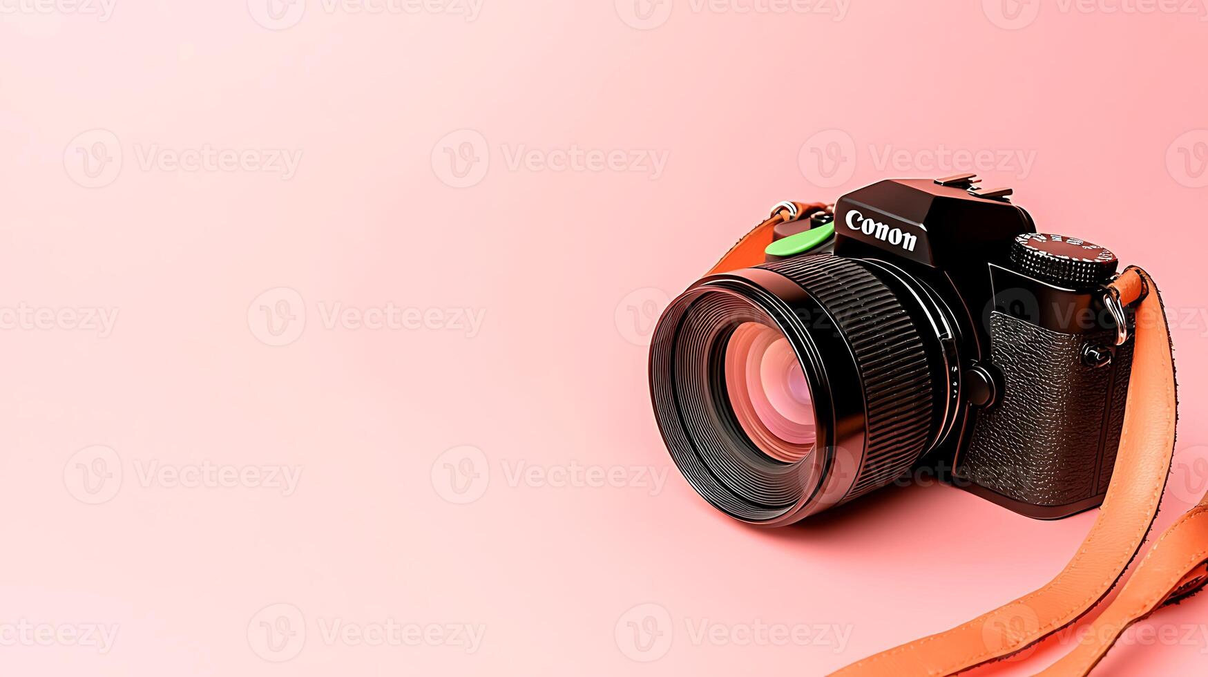 A sleek black camera with an orange strap positioned on a soft pink background, ideal for photography enthusiasts photo