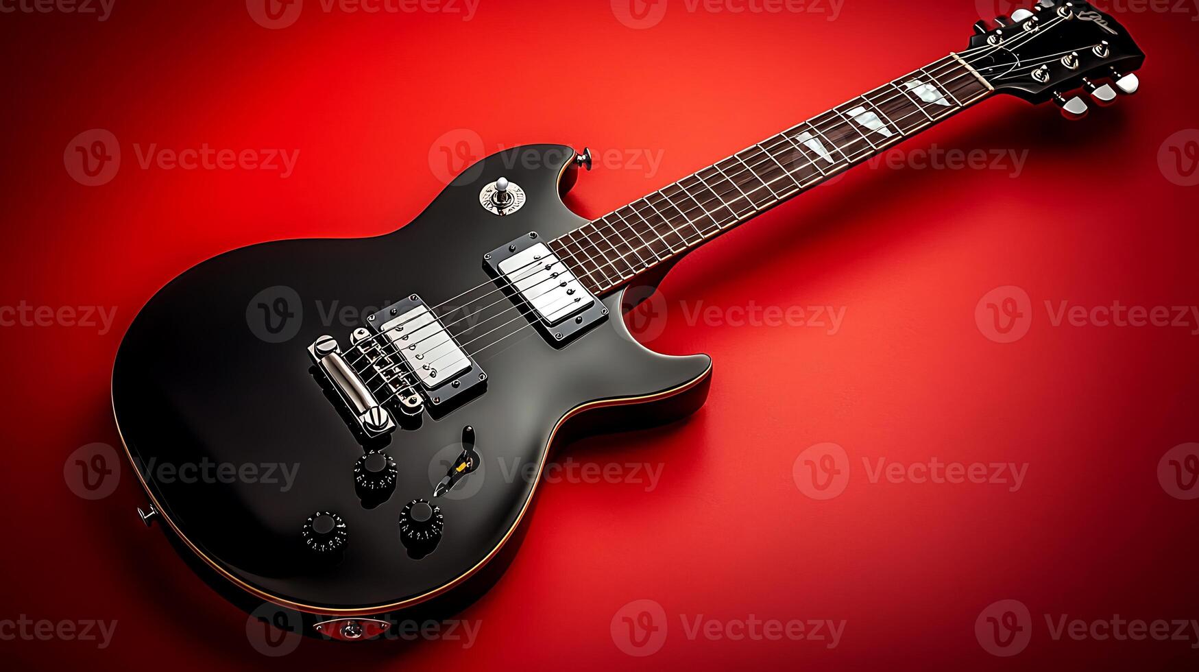 A sleek black electric guitar resting on a vibrant red background, showcasing its design and features photo