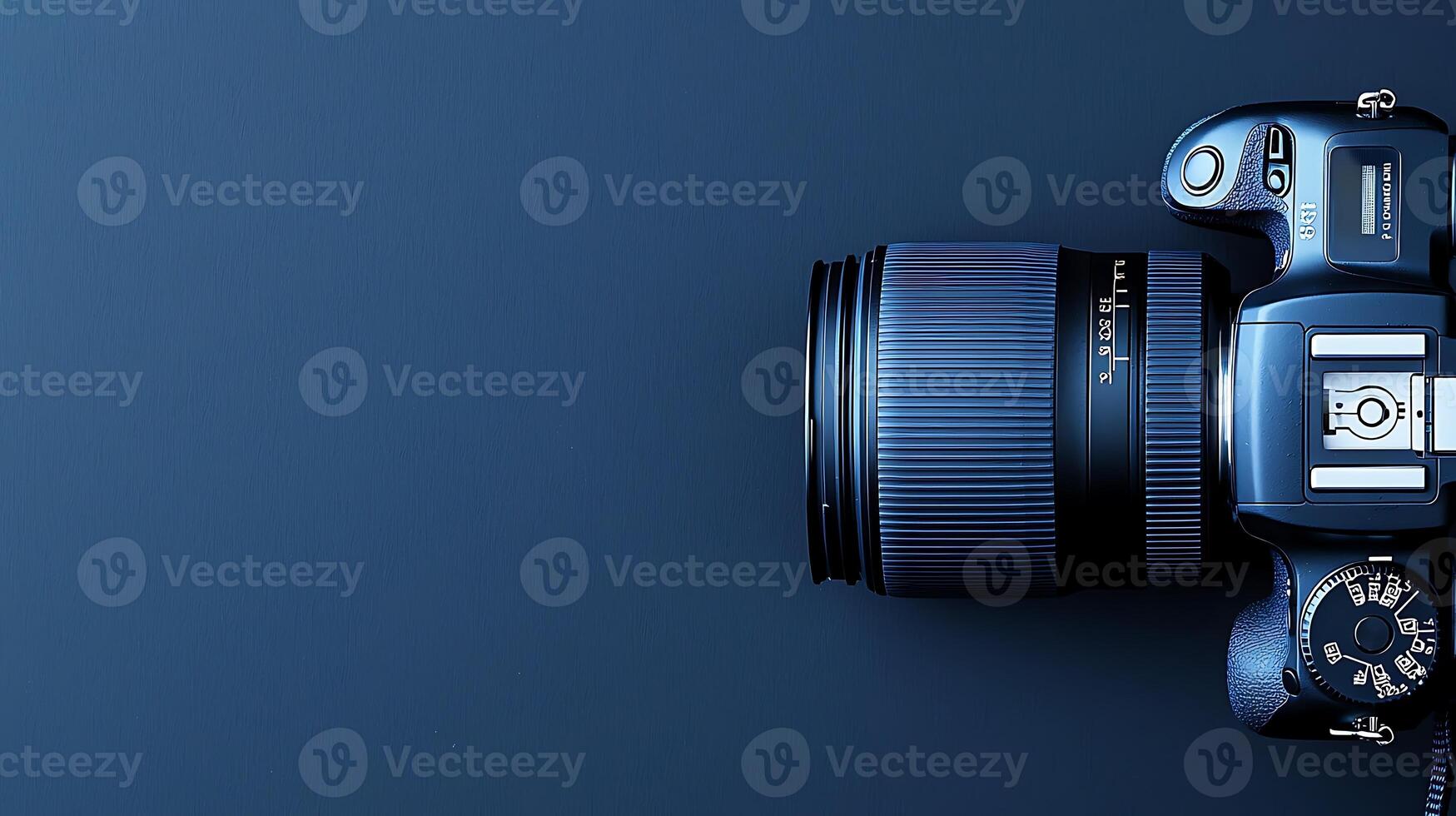 A sleek blue camera positioned on a dark blue background, showcasing its lens and design photo