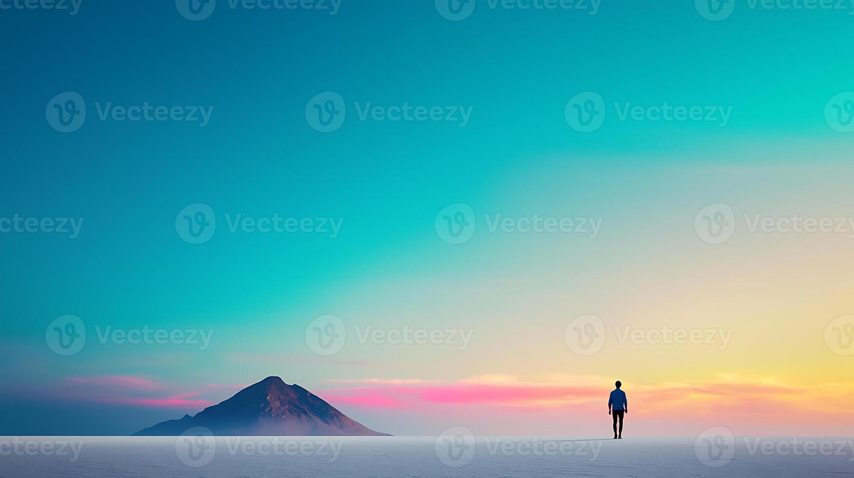 A solitary figure walks towards a vibrant sunset over a serene landscape with a mountain backdrop photo