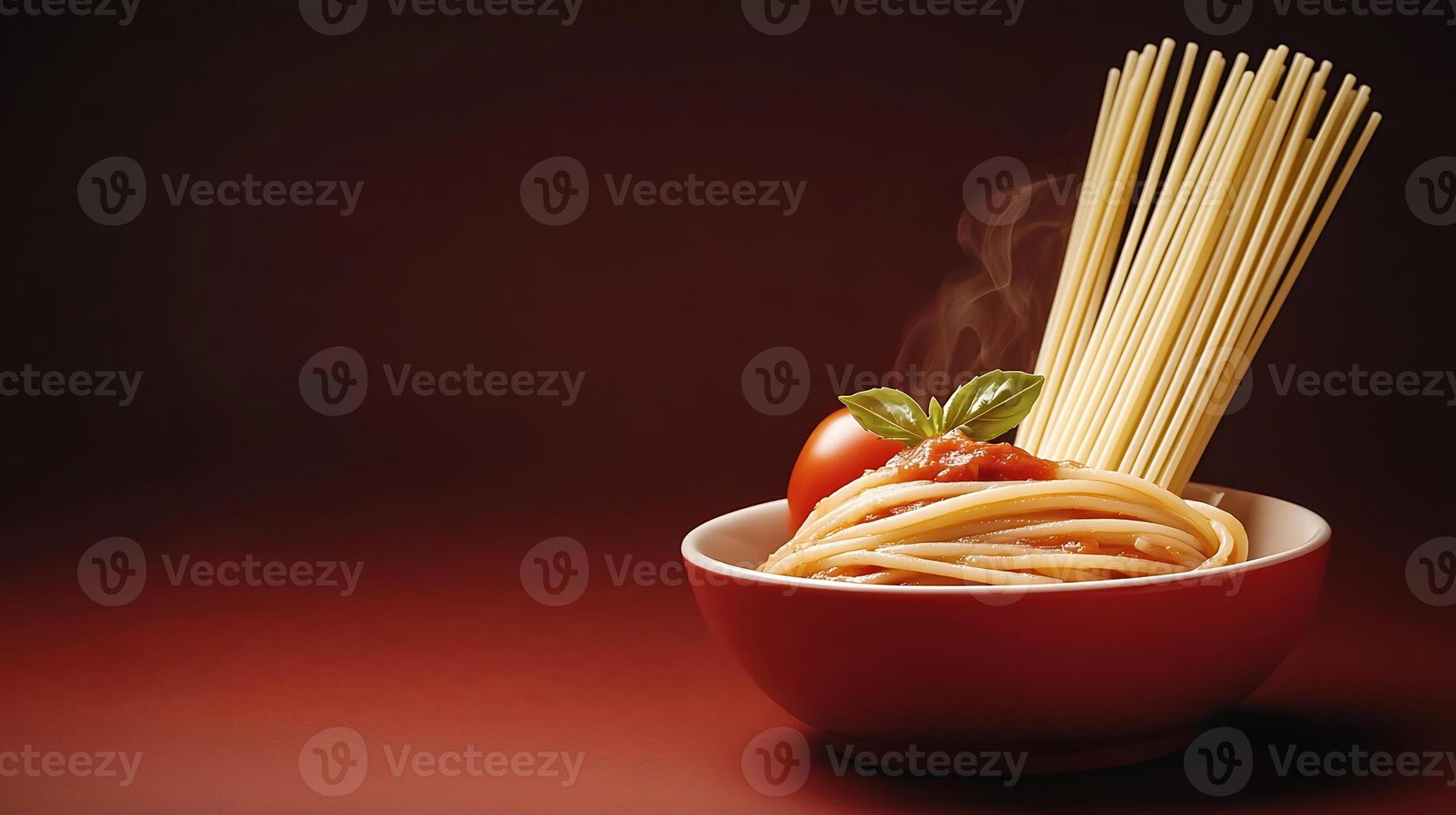 A steaming bowl of spaghetti topped with fresh basil and tomato sauce against a dark background photo