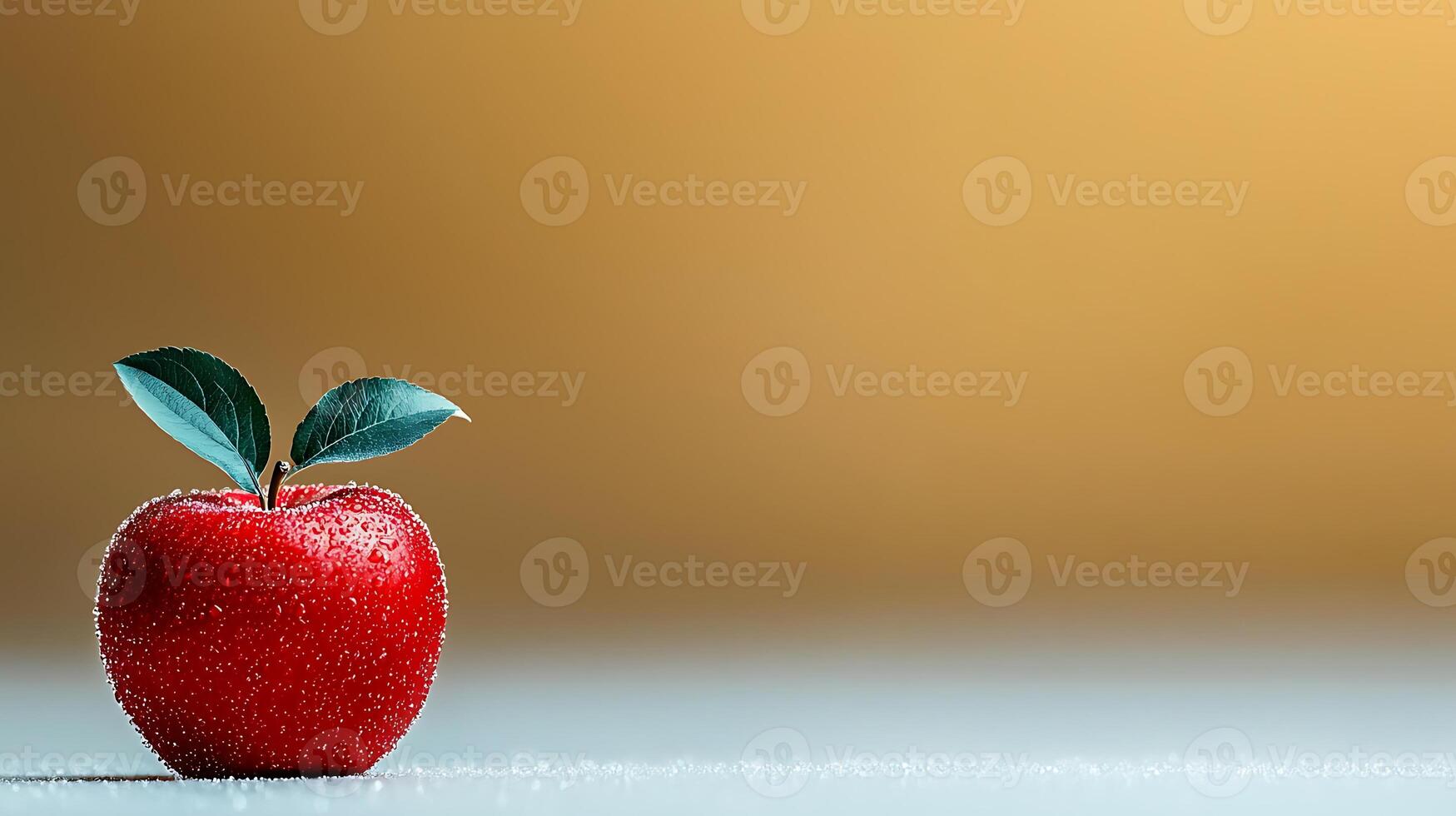 A vibrant red apple with dew drops and green leaves on a soft, blurred background photo