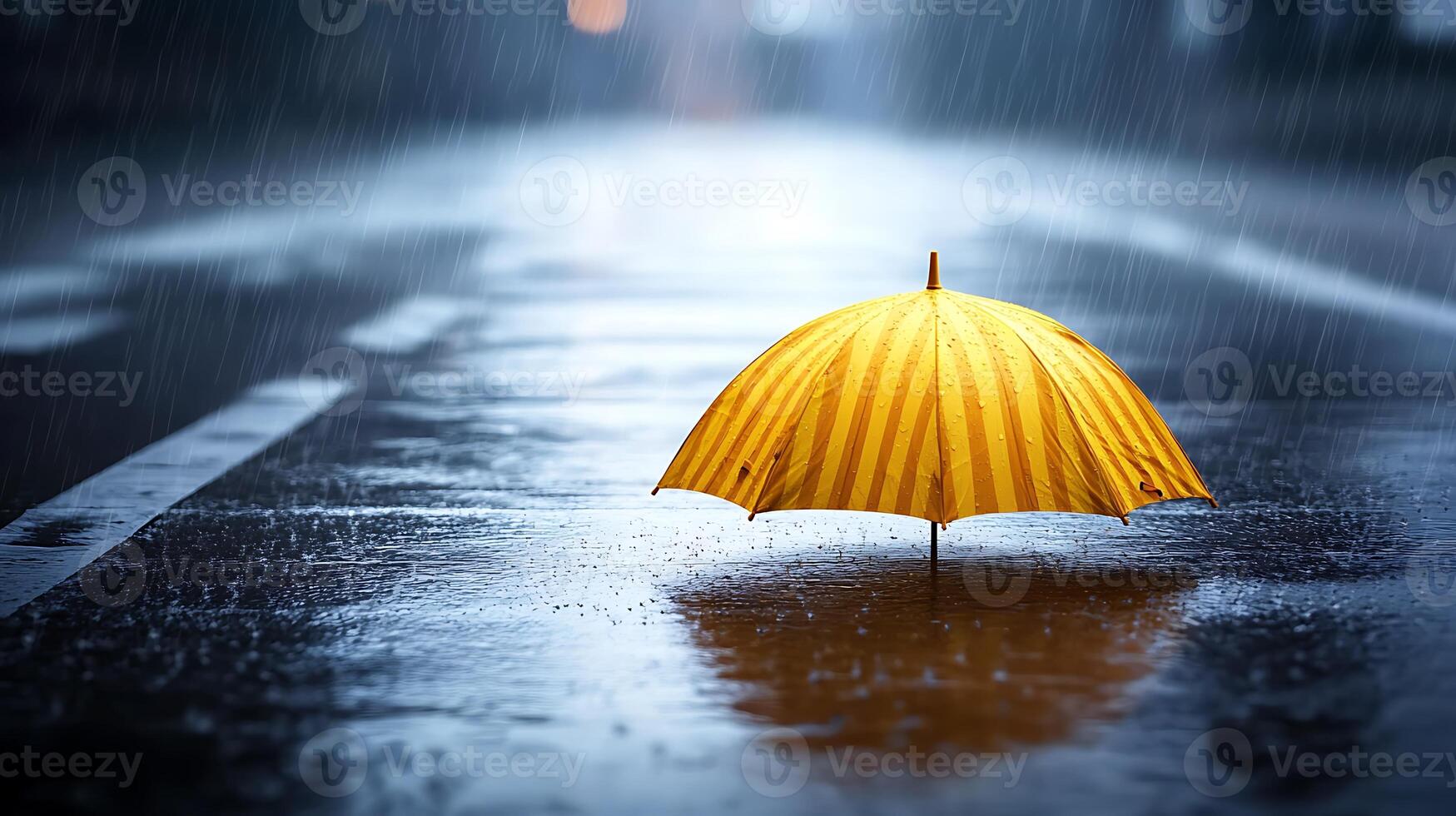 A vibrant yellow umbrella stands alone on a rainy street, reflecting puddles and urban ambiance photo
