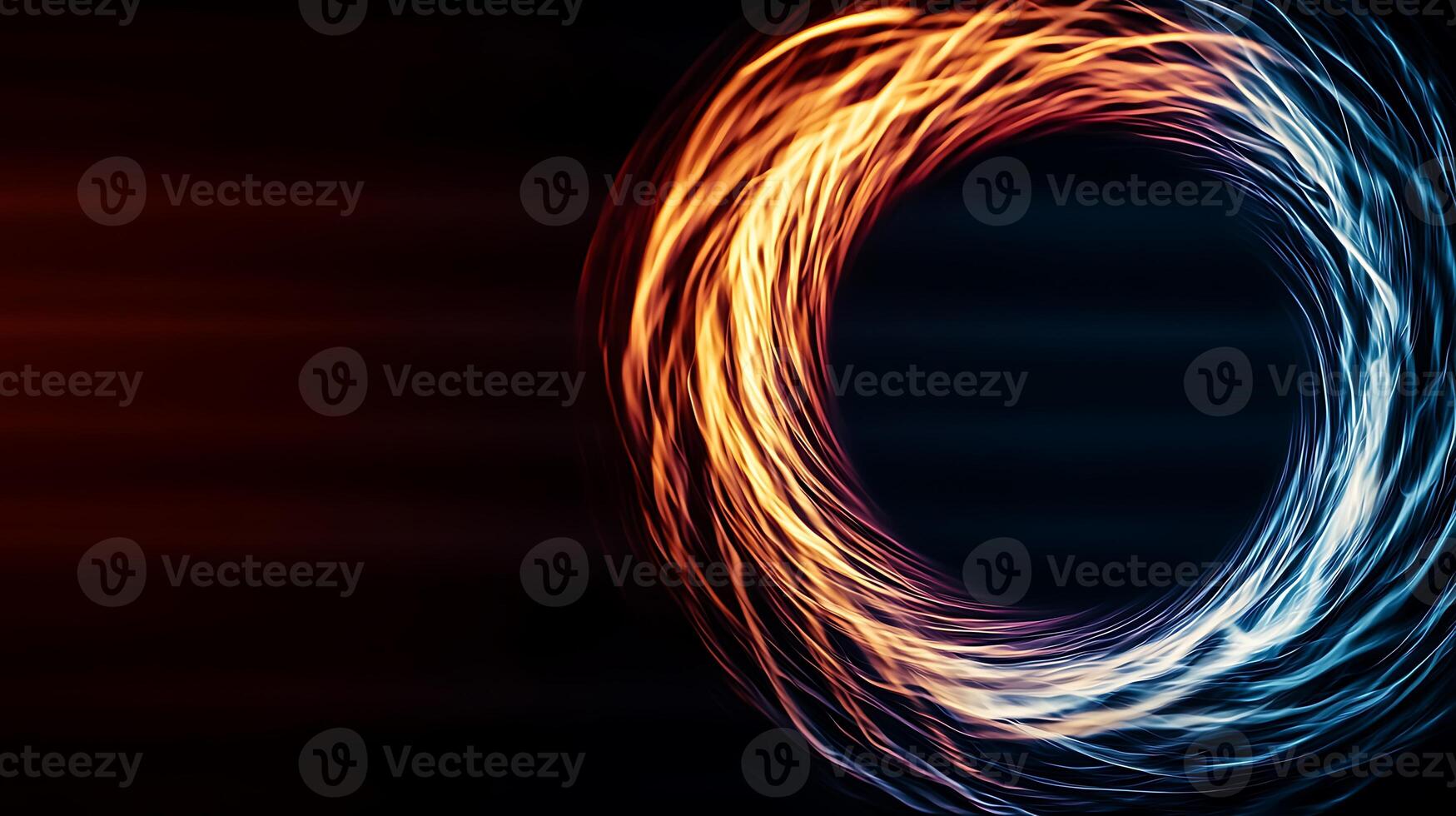 Abstract swirl of orange and blue light creating a dynamic sense of motion against a dark backdrop photo