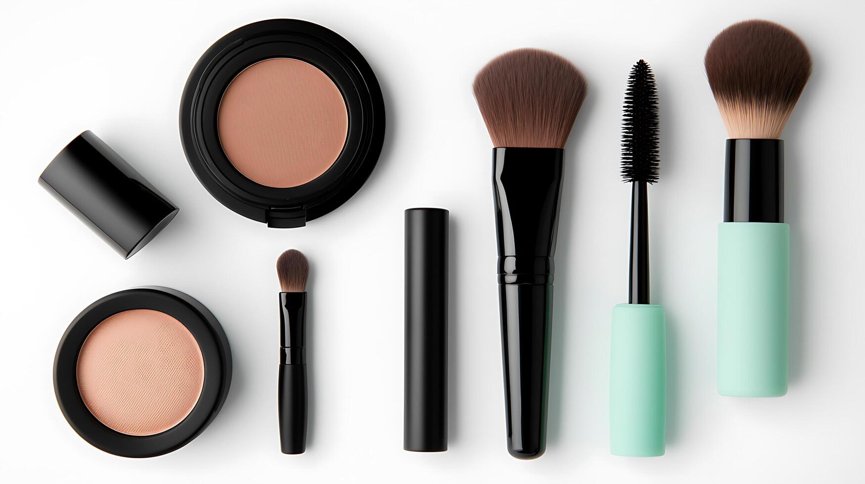 Arrangement of various makeup products including brushes, mascara, and powders on a clean background photo