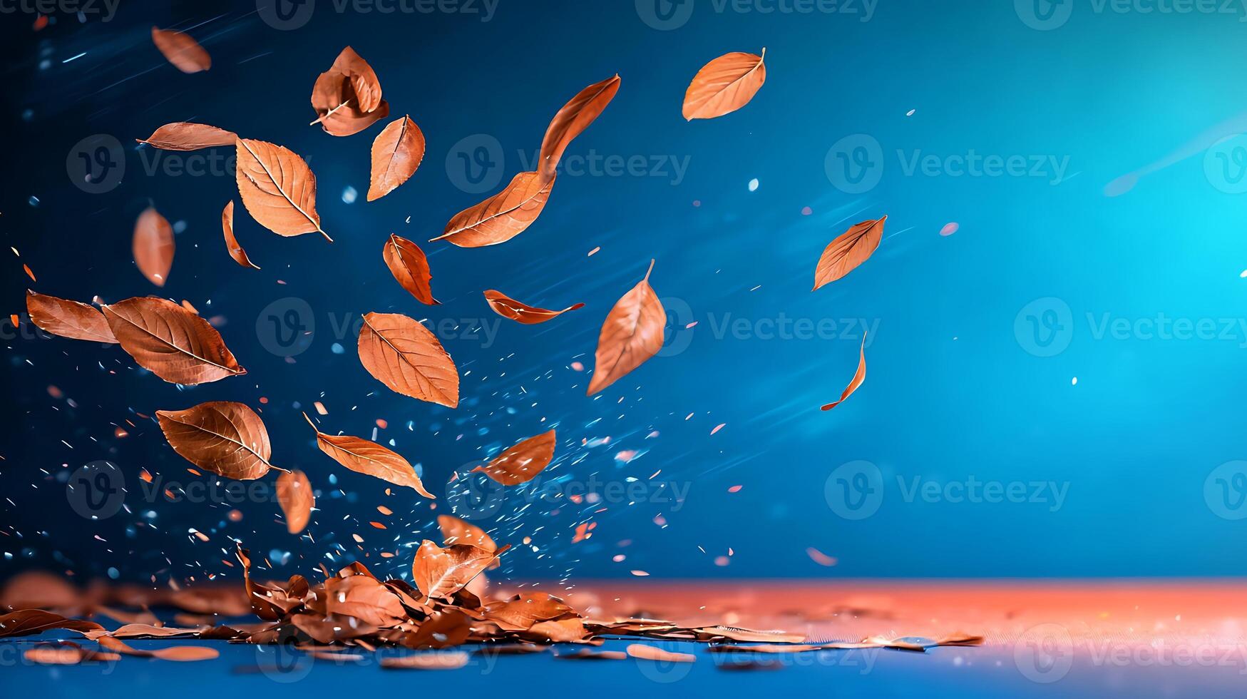 Autumn leaves swirling in the air against a vibrant blue and orange background, creating a dynamic scene photo