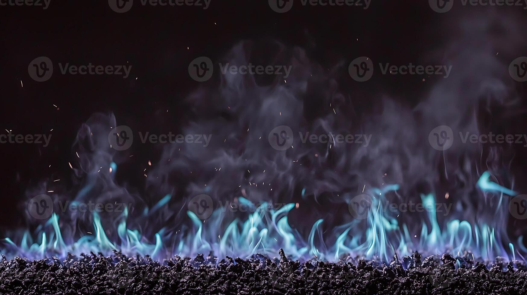 Blue flames and smoke rising from dark gravel surface, creating a dramatic and mystical atmosphere photo
