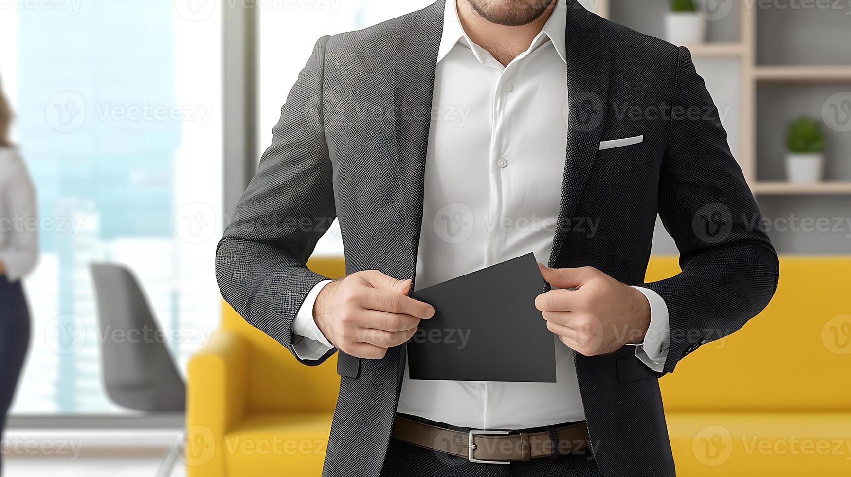 Business professional discreetly retrieving a document from his suit jacket in a modern office setting photo