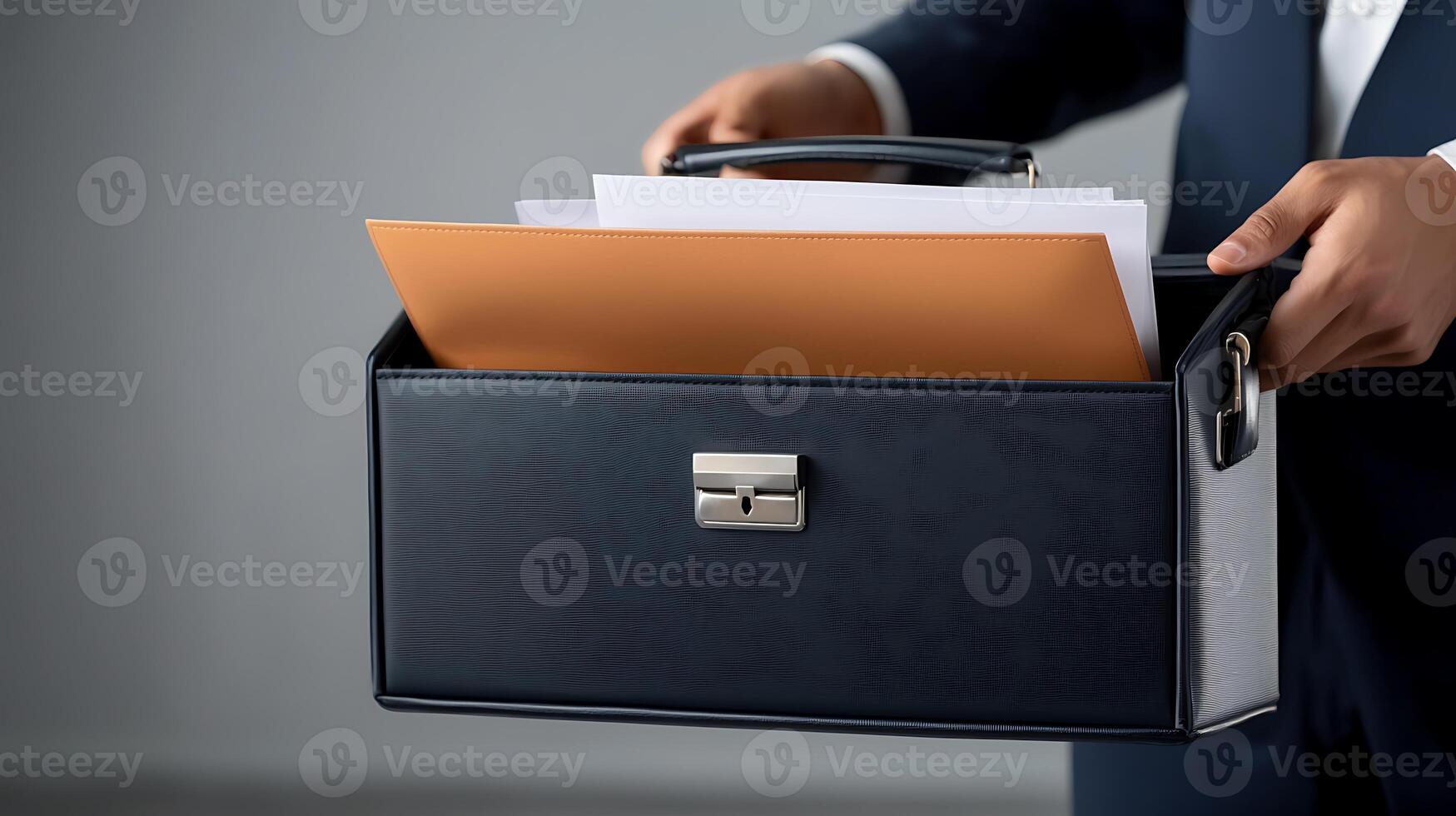 Business professional holding a briefcase filled with documents in a modern office setting photo