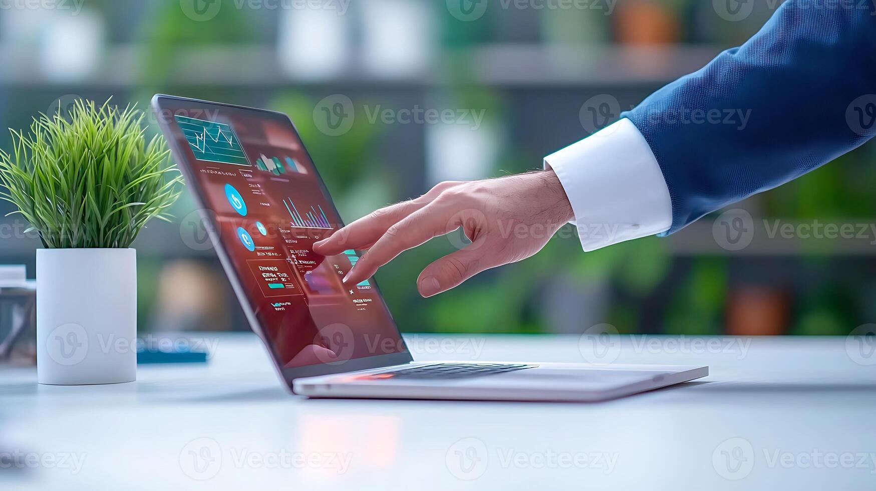 Business professional interacting with a laptop displaying data analytics in a modern office setting photo