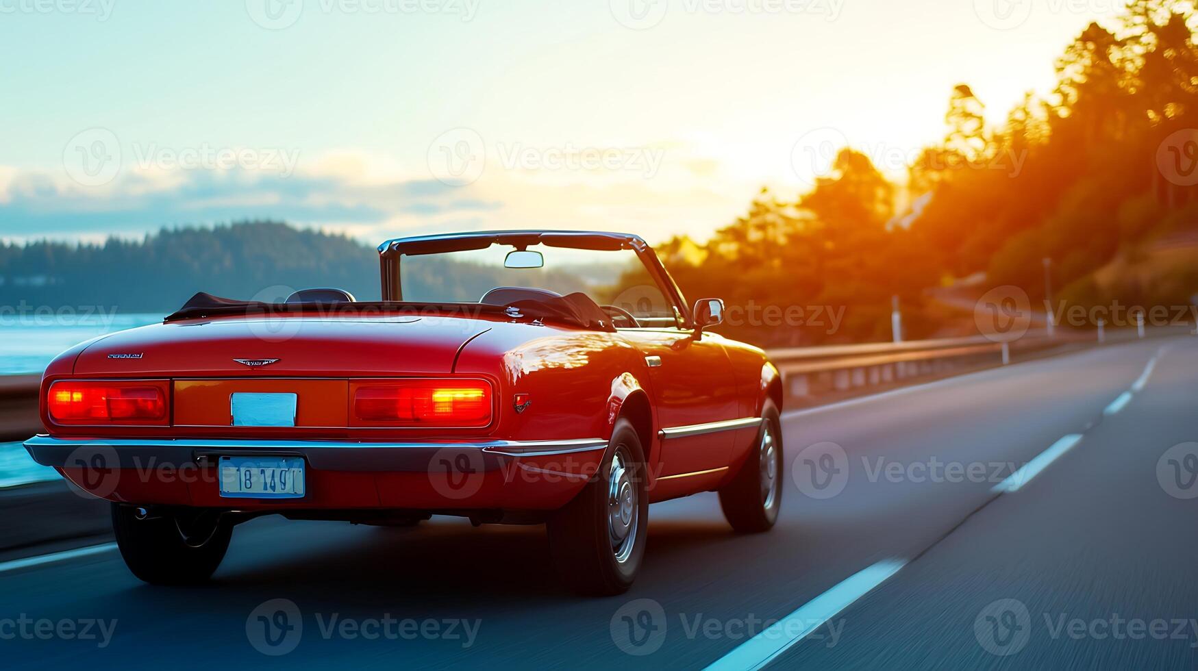 Classic convertible car cruising along a scenic coastal highway during sunset photo
