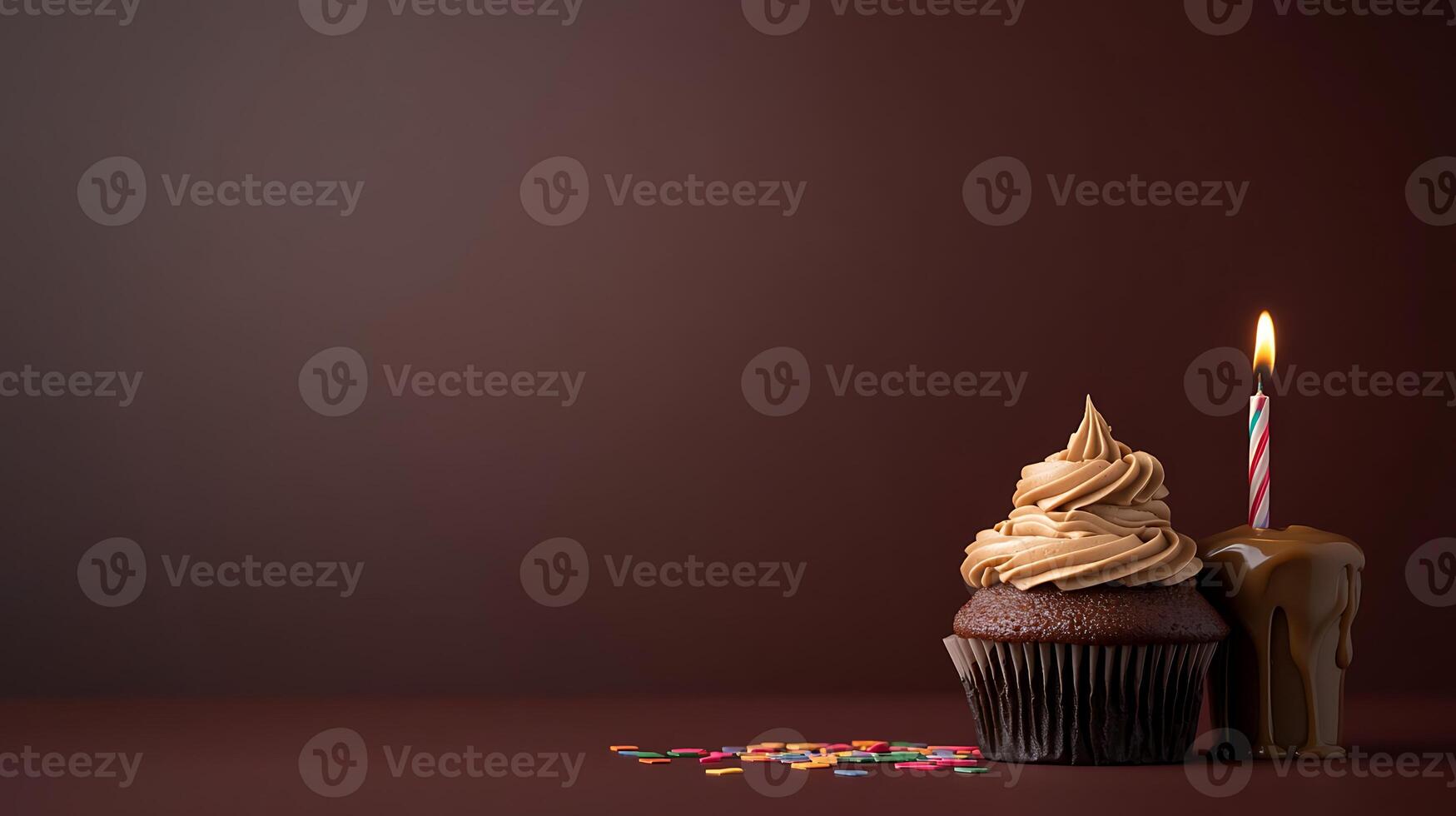 Chocolate cupcake with frosting and candle, decorated with sprinkles on a dark background photo