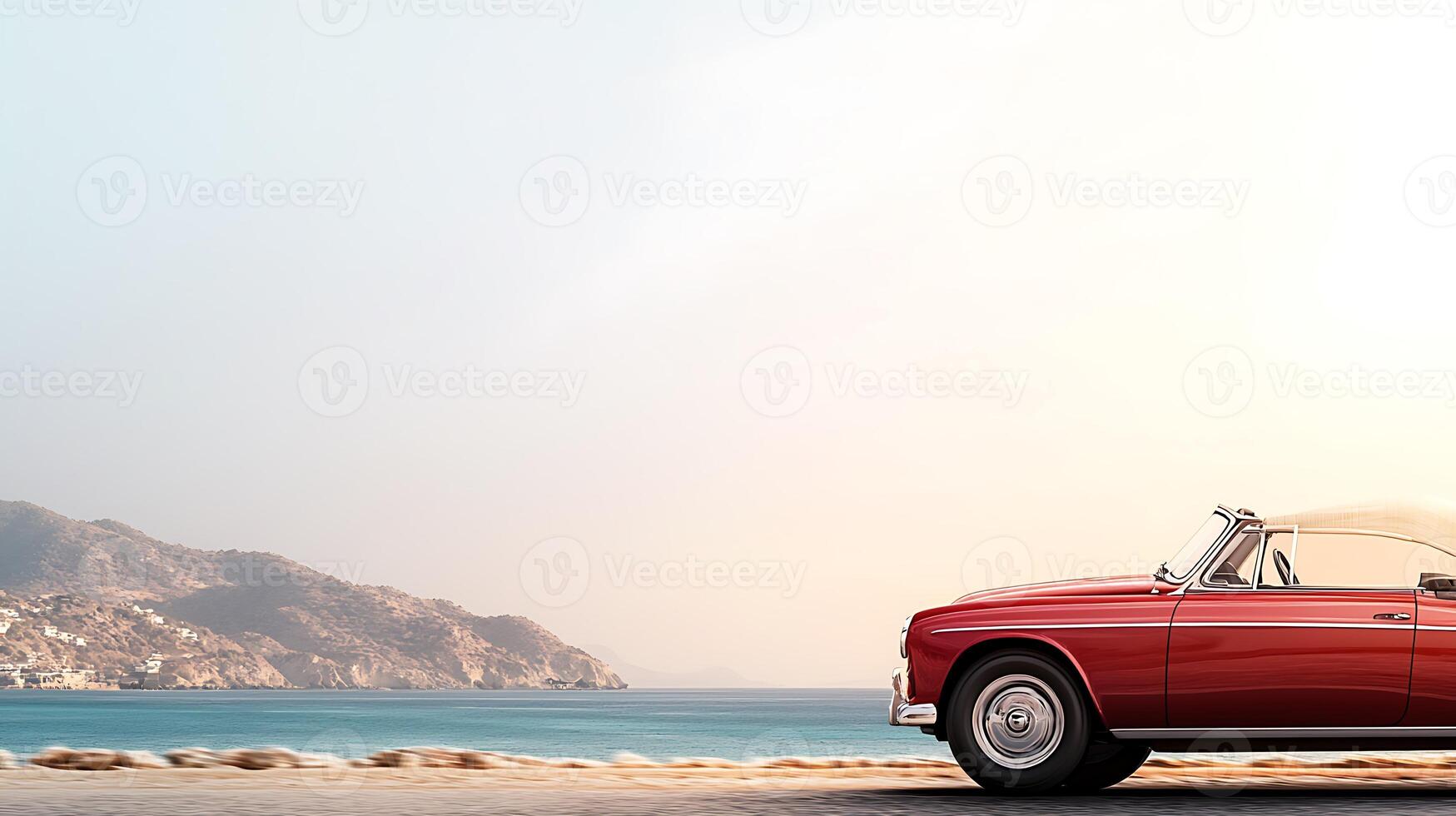 Classic red convertible parked by the tranquil beach during sunset, with mountains in the background photo