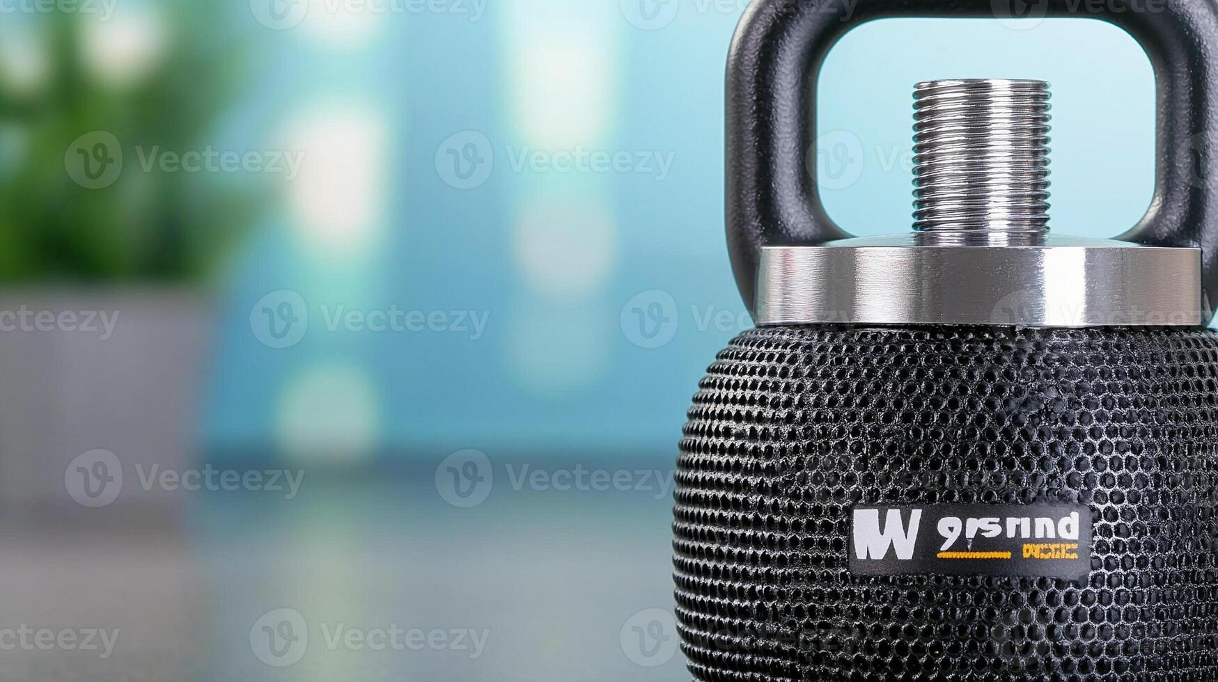 Close-up of a black kettlebell on a blurred background with greenery, ideal for fitness promotion photo