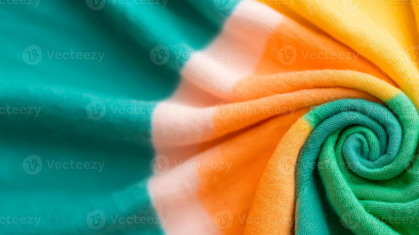 Close-up of a colorful, swirling fabric showcasing vibrant teal, orange, and yellow hues photo