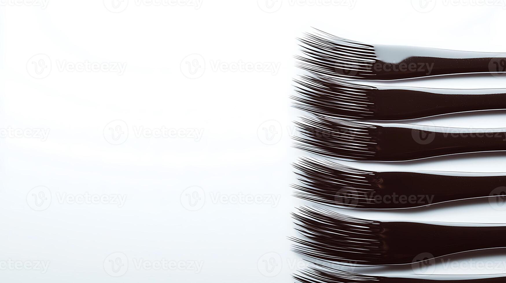Close-up of a row of sleek black forks against a minimalist white background, ideal for culinary themes photo