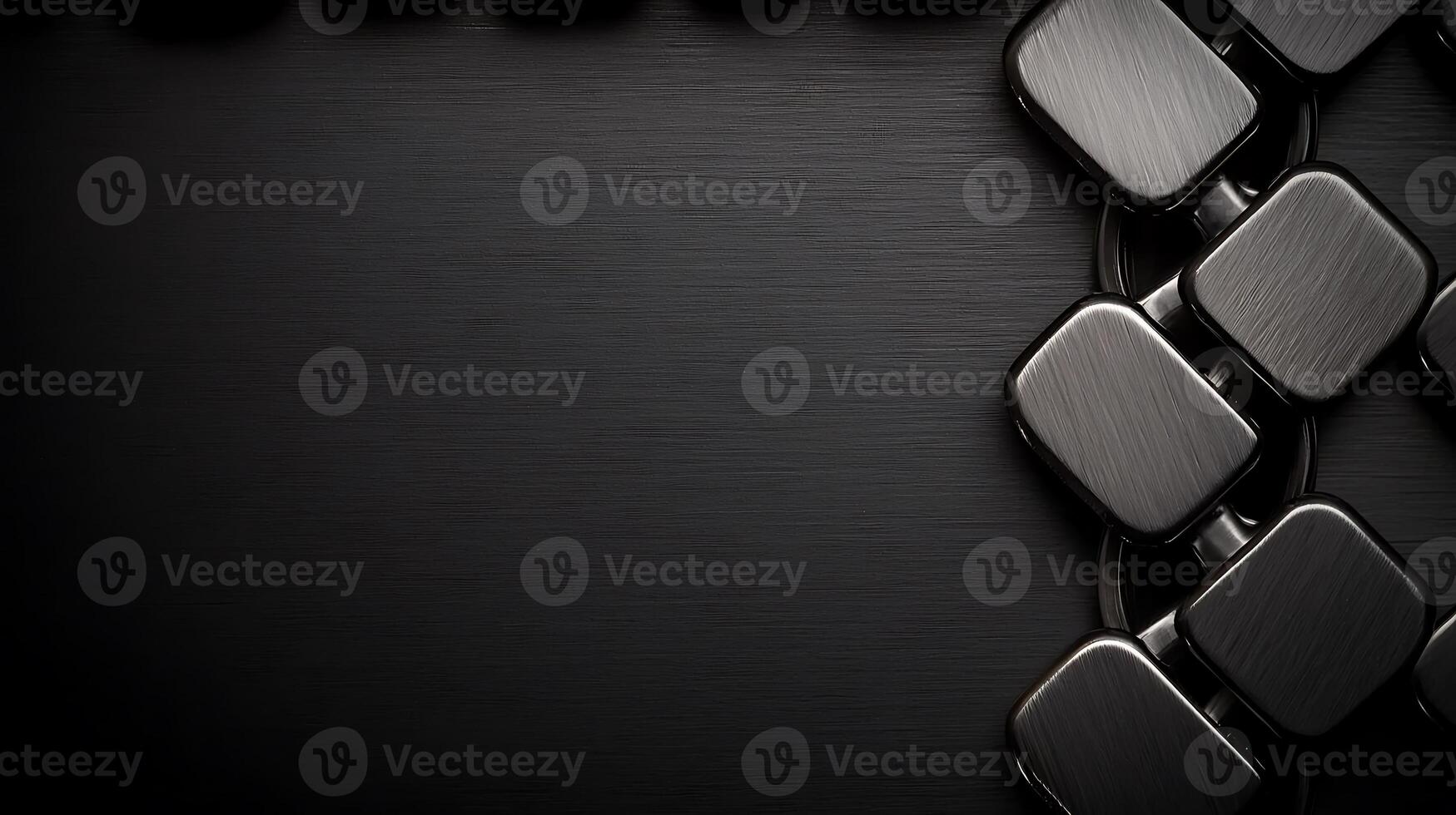 Close-up of a sleek, modern black chain on a brushed metal background with subtle reflections photo