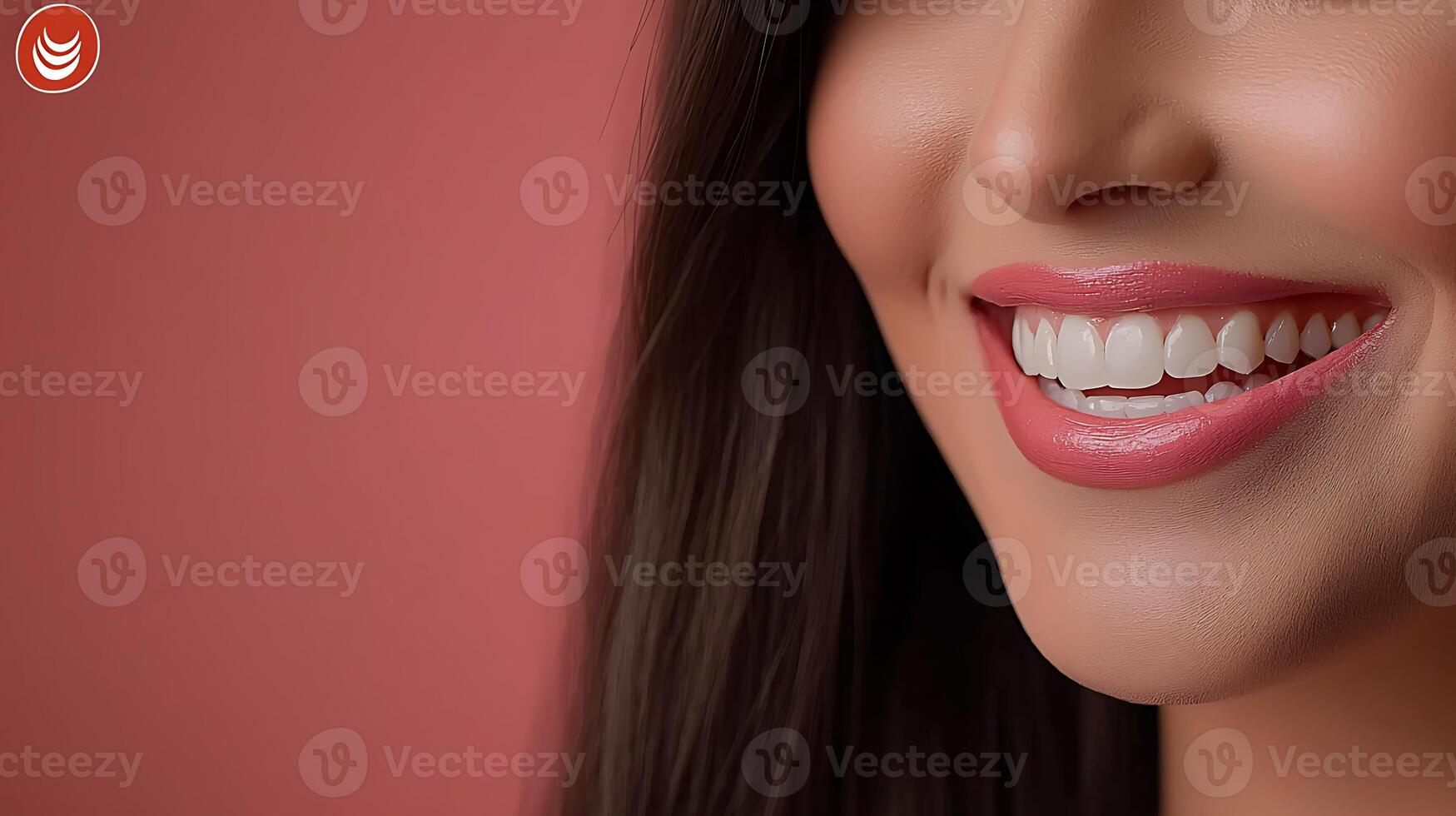 Close-up of a smiling woman with glossy lips and straight teeth against a soft pink background photo