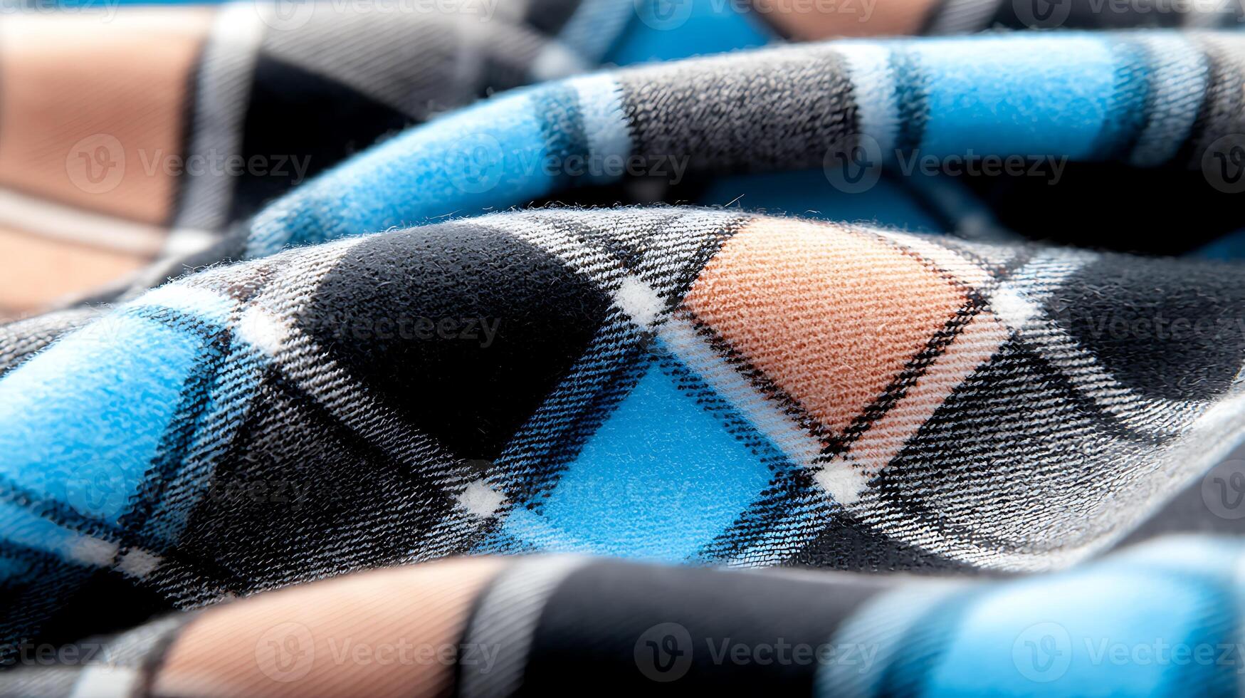 Close-up of a soft, patterned fabric showcasing a blue and black plaid design with folds photo