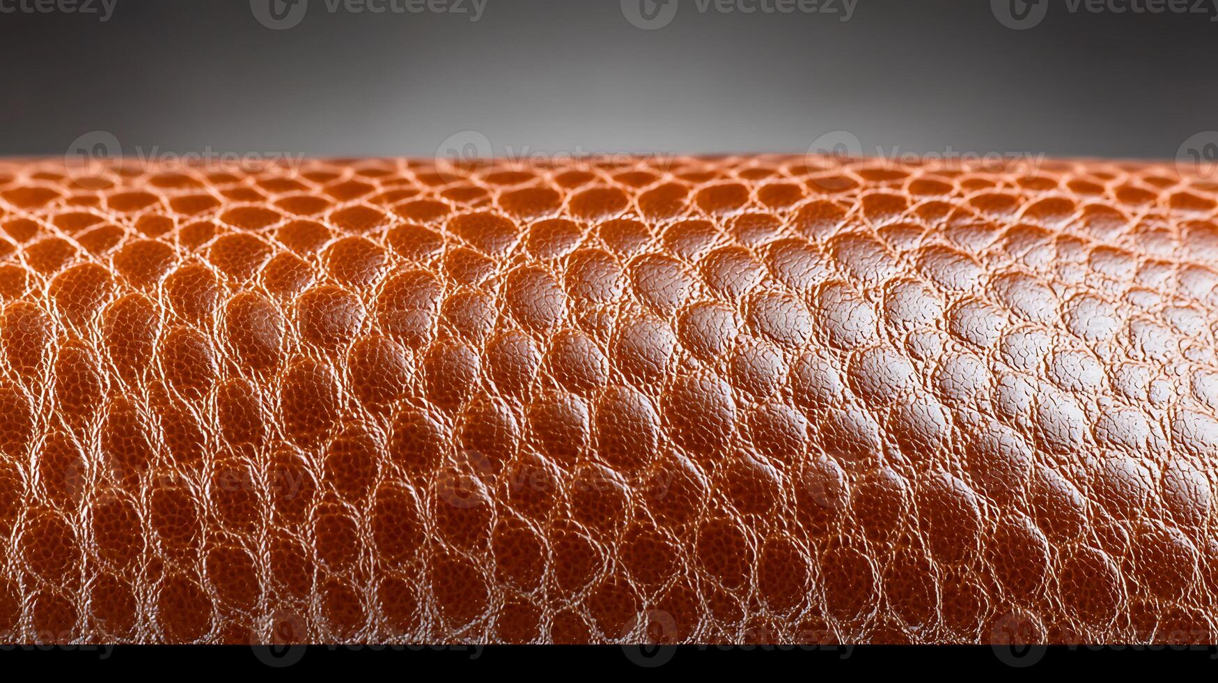 Close-up of a textured brown leather surface showcasing intricate patterns and shine photo
