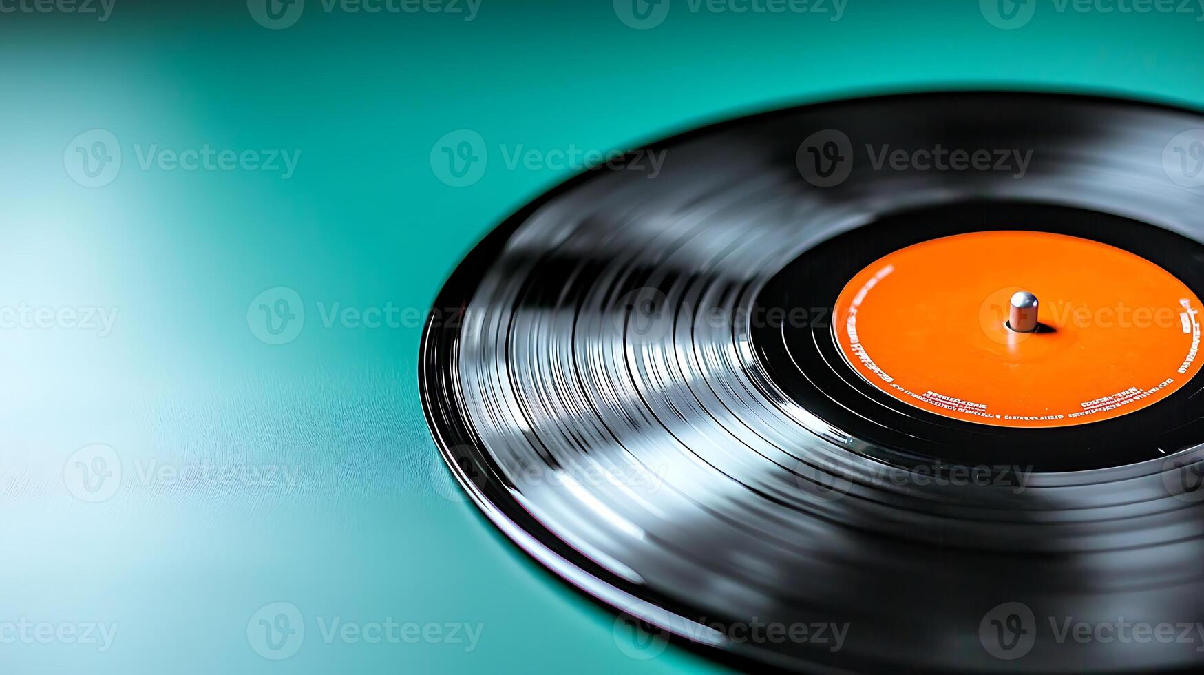 Close-up of a vinyl record on a teal background, showcasing its grooves and label details photo