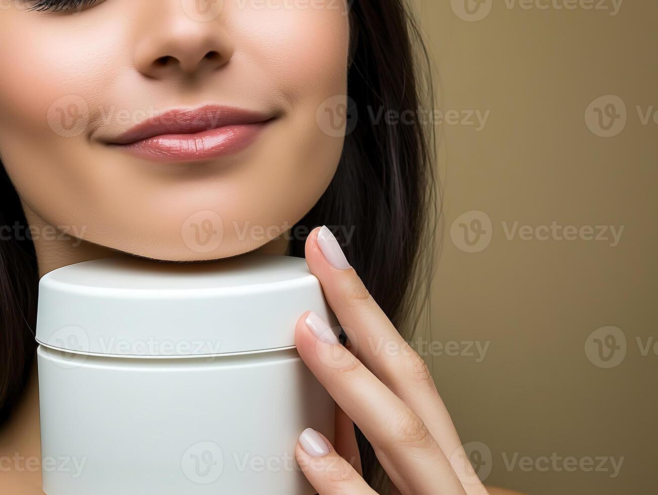 Close-up of a woman gently holding a skincare jar, smiling, with a neutral background enhancing focus photo