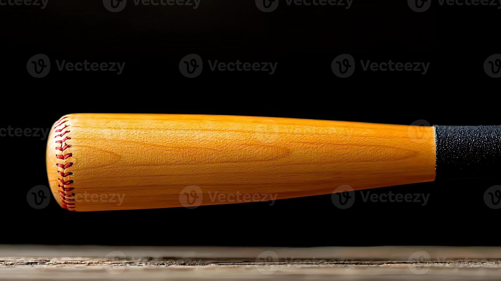 Close-up of a wooden baseball bat resting on a rustic wooden surface with a dark background photo