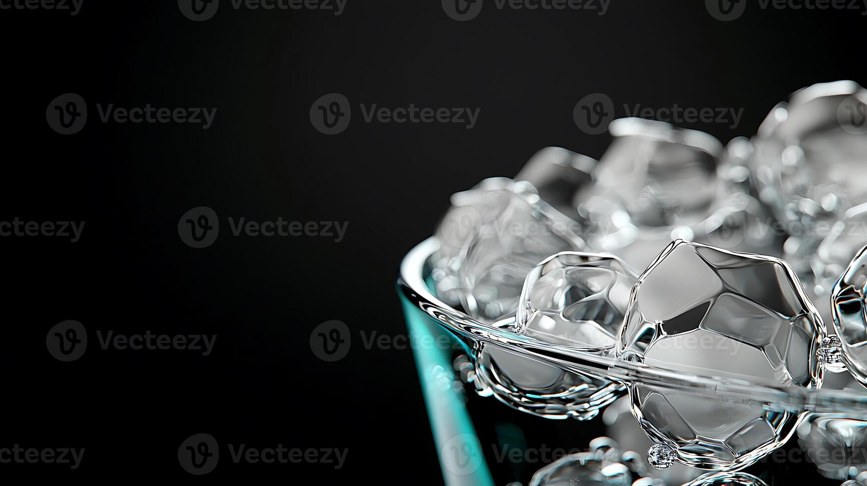 Close-up of crystal-clear ice cubes in a glass bowl against a dark background, highlighting texture photo