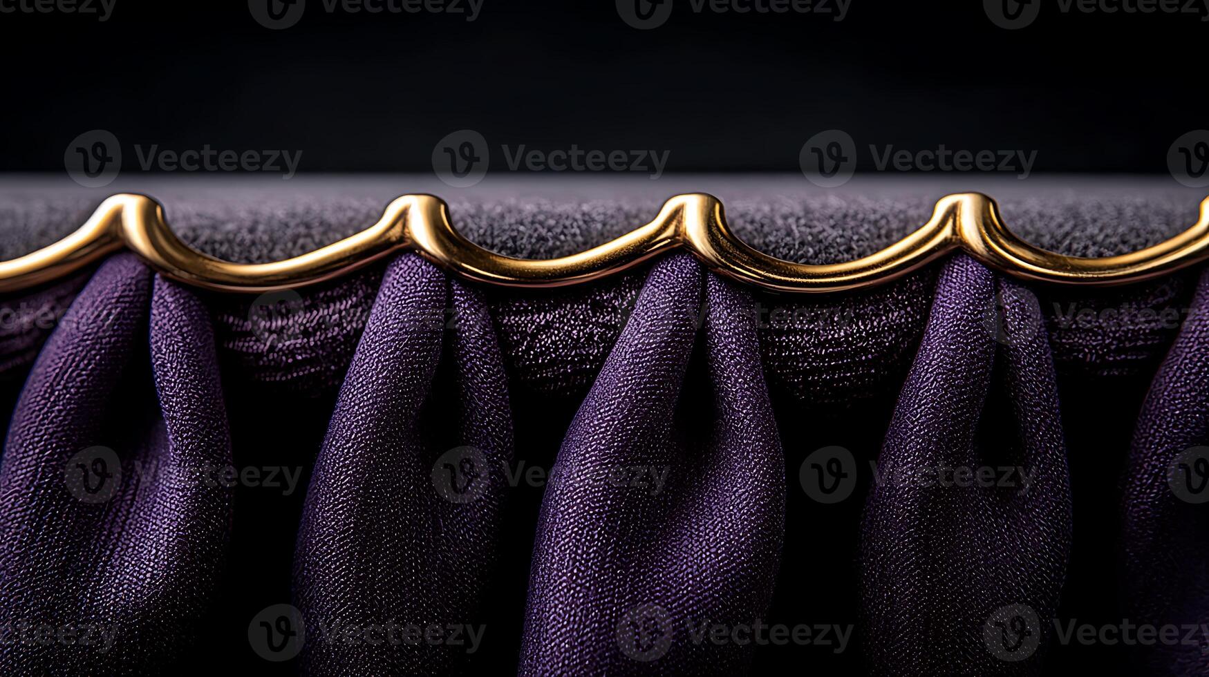 Close-up of elegant purple fabric with golden trim showcasing intricate draping and texture photo