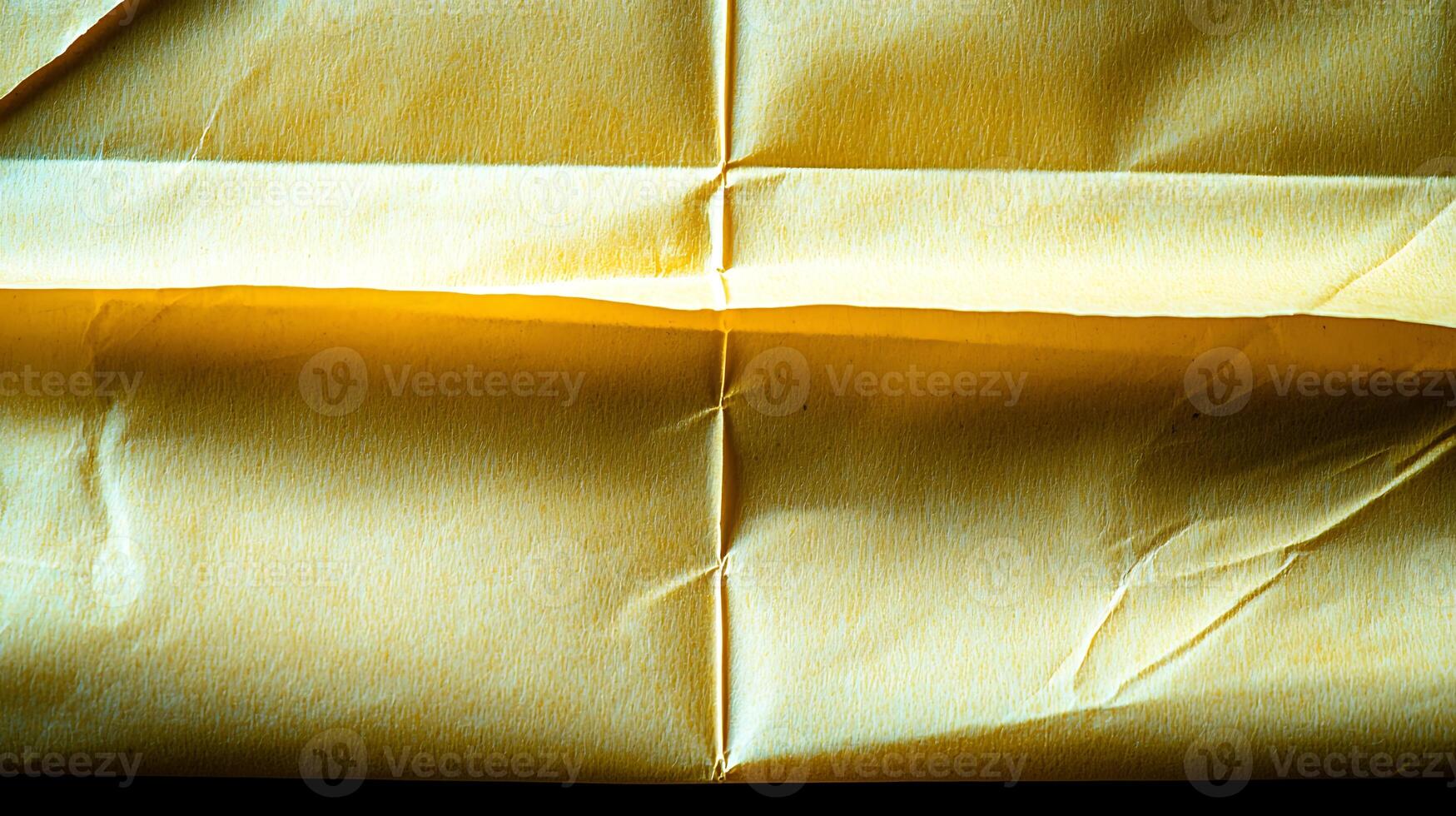 Close-up of crumpled yellow paper showcasing texture and subtle shadows for design use photo