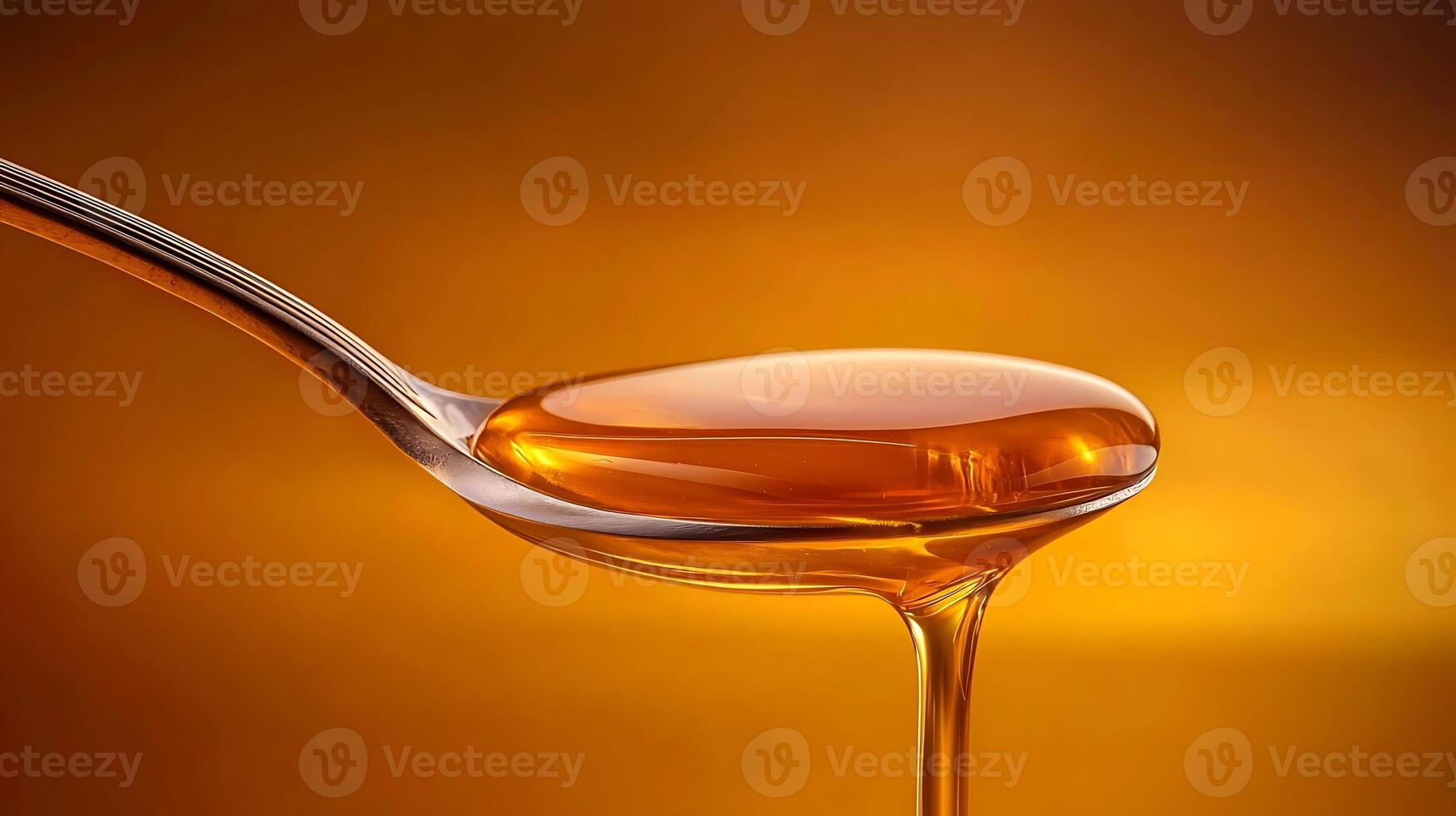Close-up of honey dripping from a spoon against a warm, golden background, emphasizing texture photo
