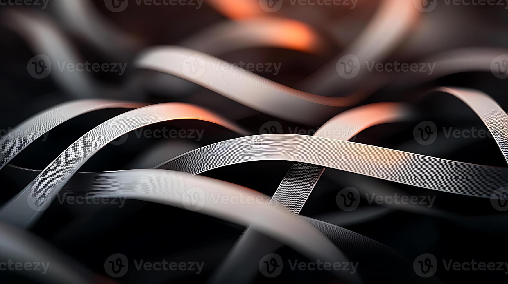 Close-up of intertwined metallic ribbons reflecting light, creating an abstract visual effect photo