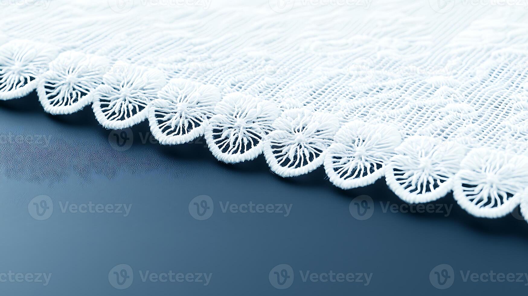 Close-up view of intricate lace fabric edge on a smooth surface, showcasing delicate design details photo